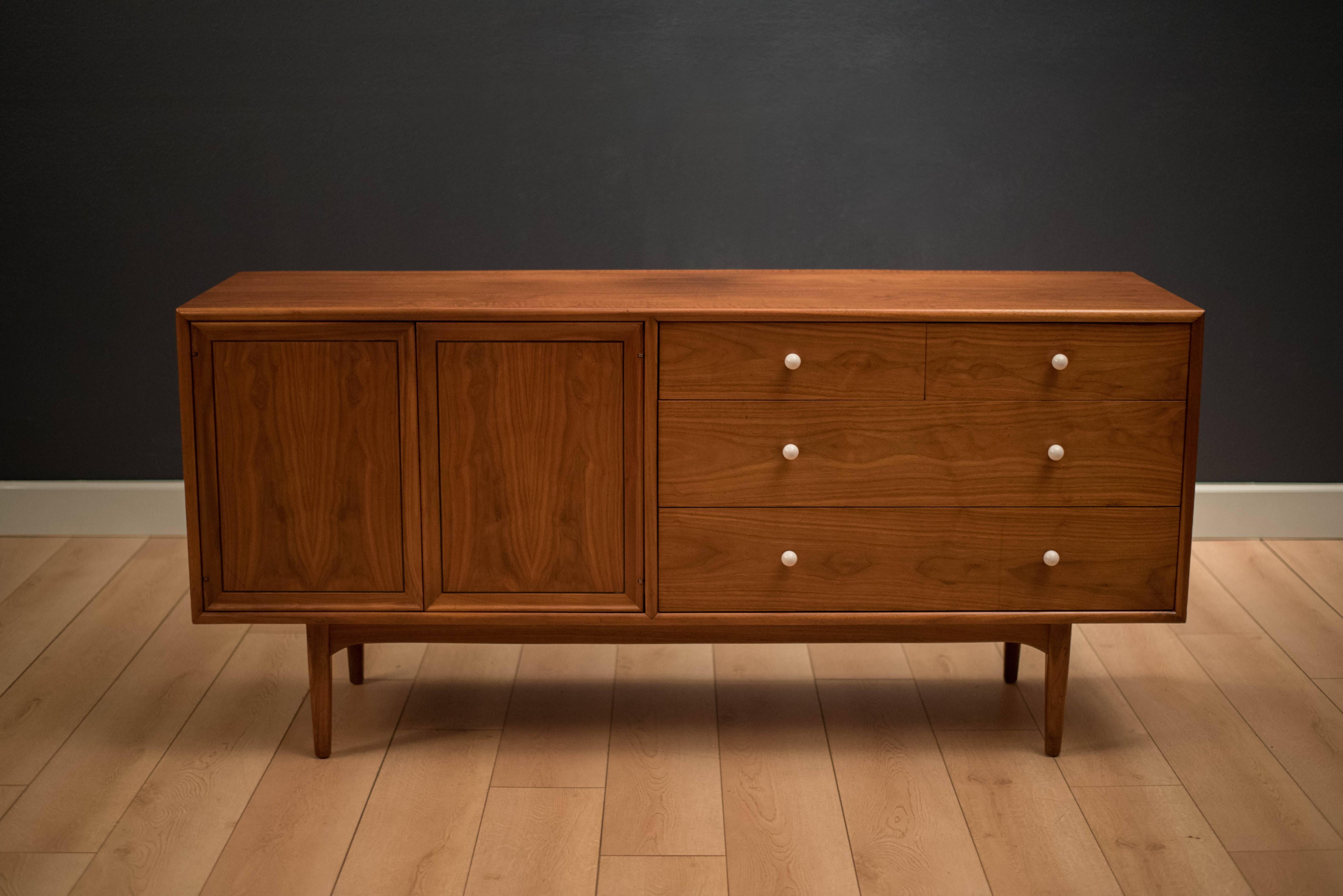 Mid-Century Drexel declaration dresser by Kipp Stewart and Stewart McDougall. This piece is equipped with ten drawers accessorized with signature white porcelain pulls. Case piece is bookmatched with black walnut grains.