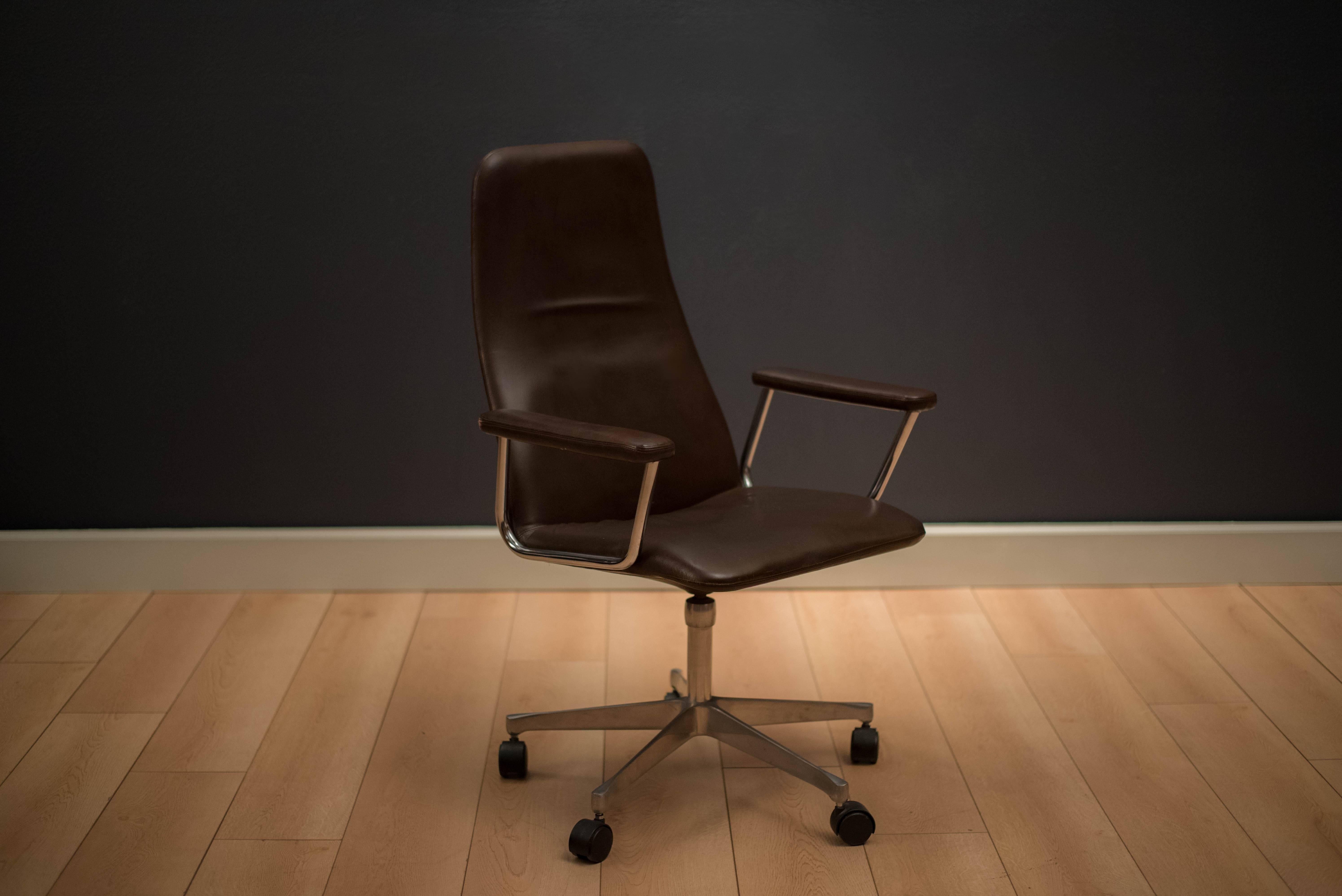 Vintage swivel office chair by Kevi A/S, circa 1960s. This piece features the original brown leather upholstery and aluminum base.