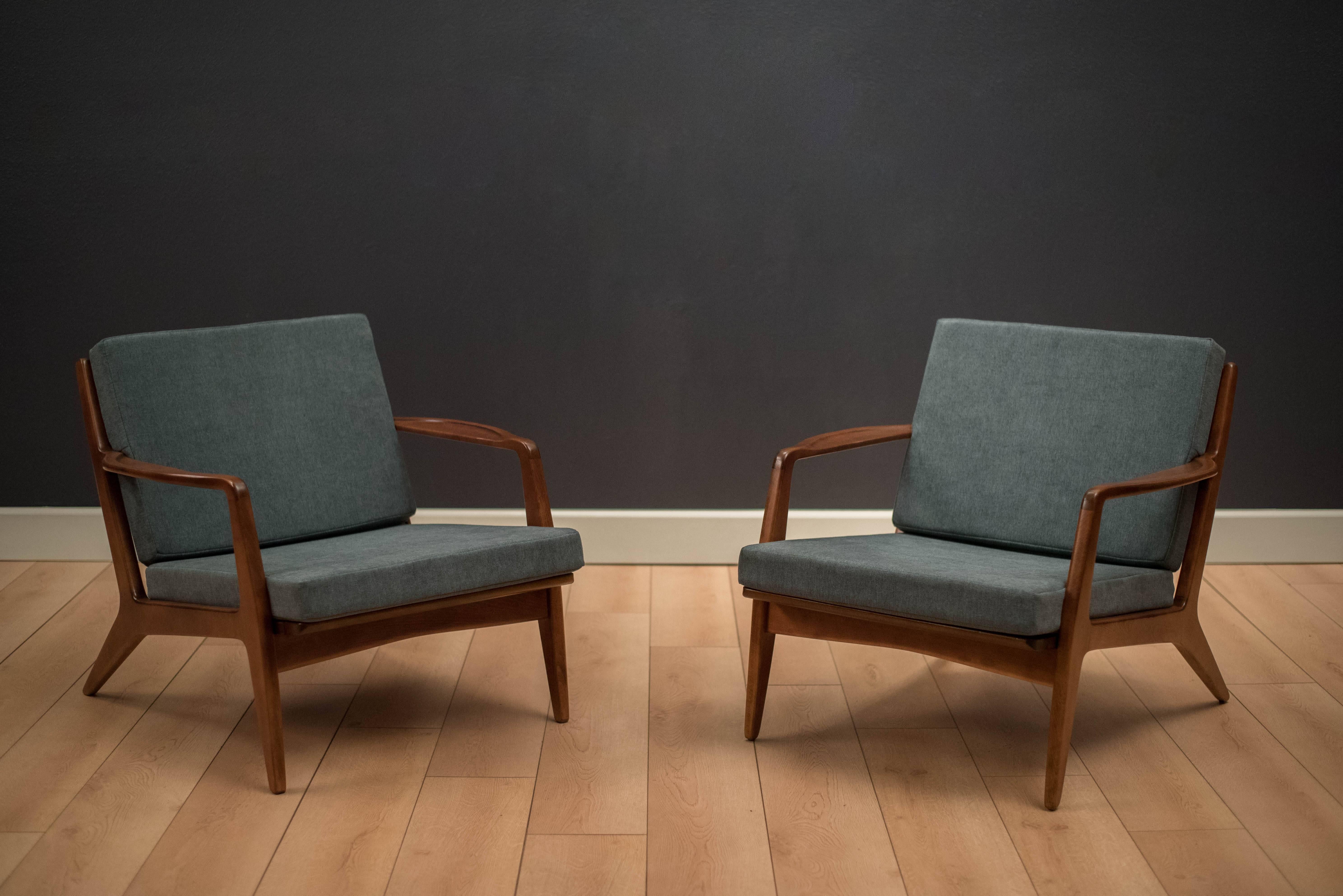 Danish modern lounge chairs designed by Ib Kofod Larsen. This pair has been professionally reupholstered with brand new foam and straps. Price is for the pair. 


 