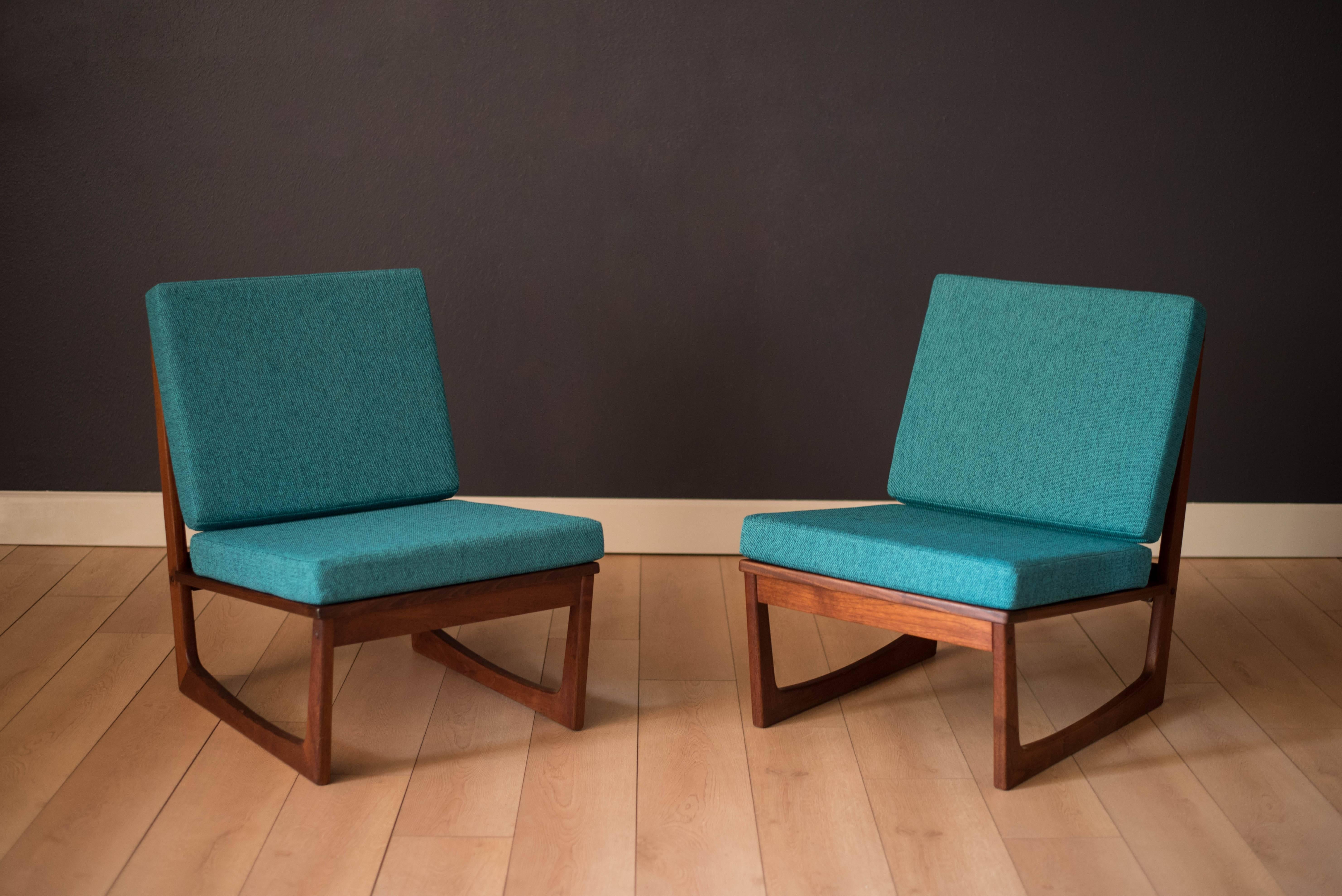 Danish slipper lounge chairs in solid teak by Jacob Kjaer. This pair has been professionally reupholstered in a woven teal fabric. Price is for the pair. 


