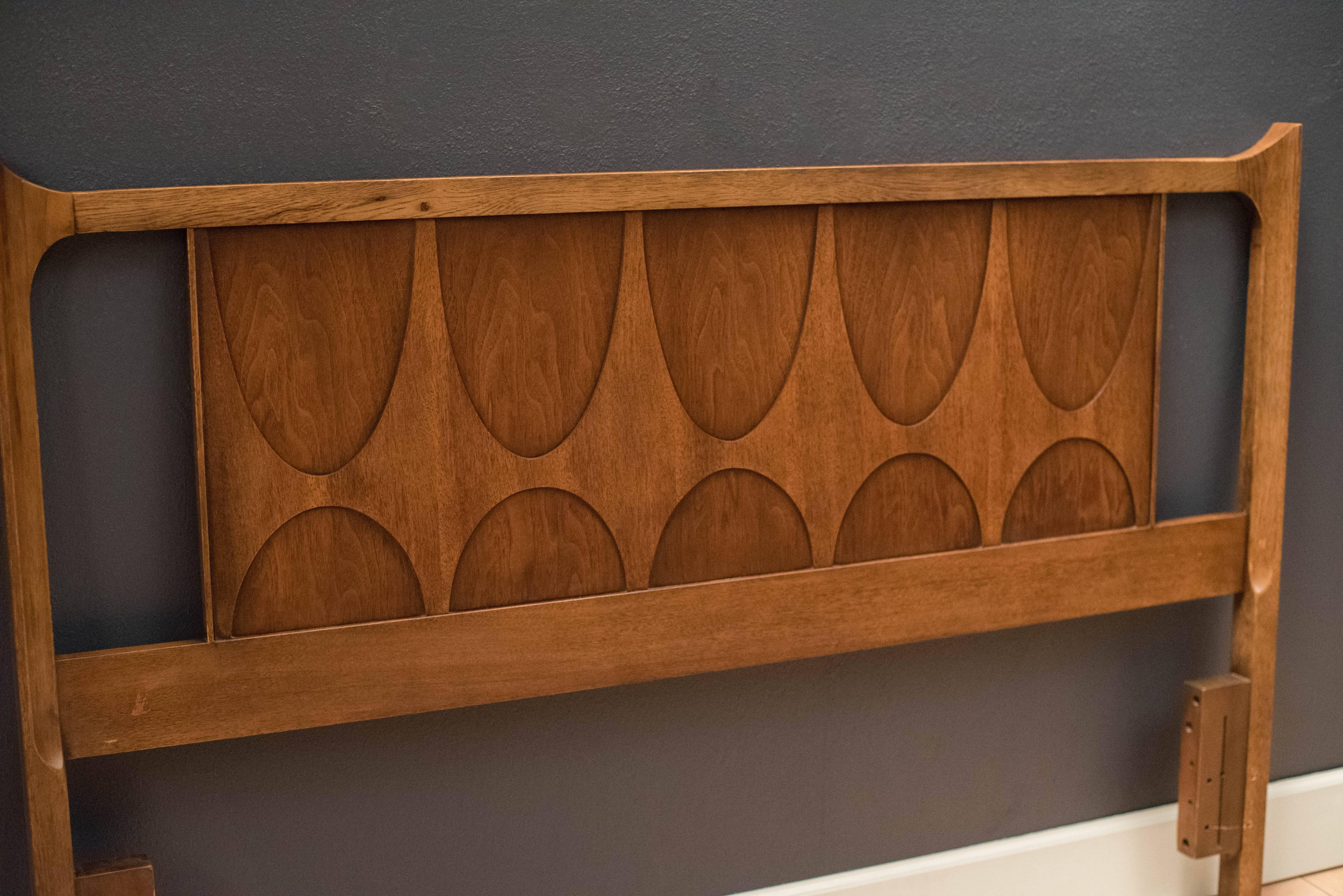 Mid-Century Brasilia Queen headboard manufactured by Broyhill, circa 1960s. This piece displays signature sculpted arches and raised edges. 

 