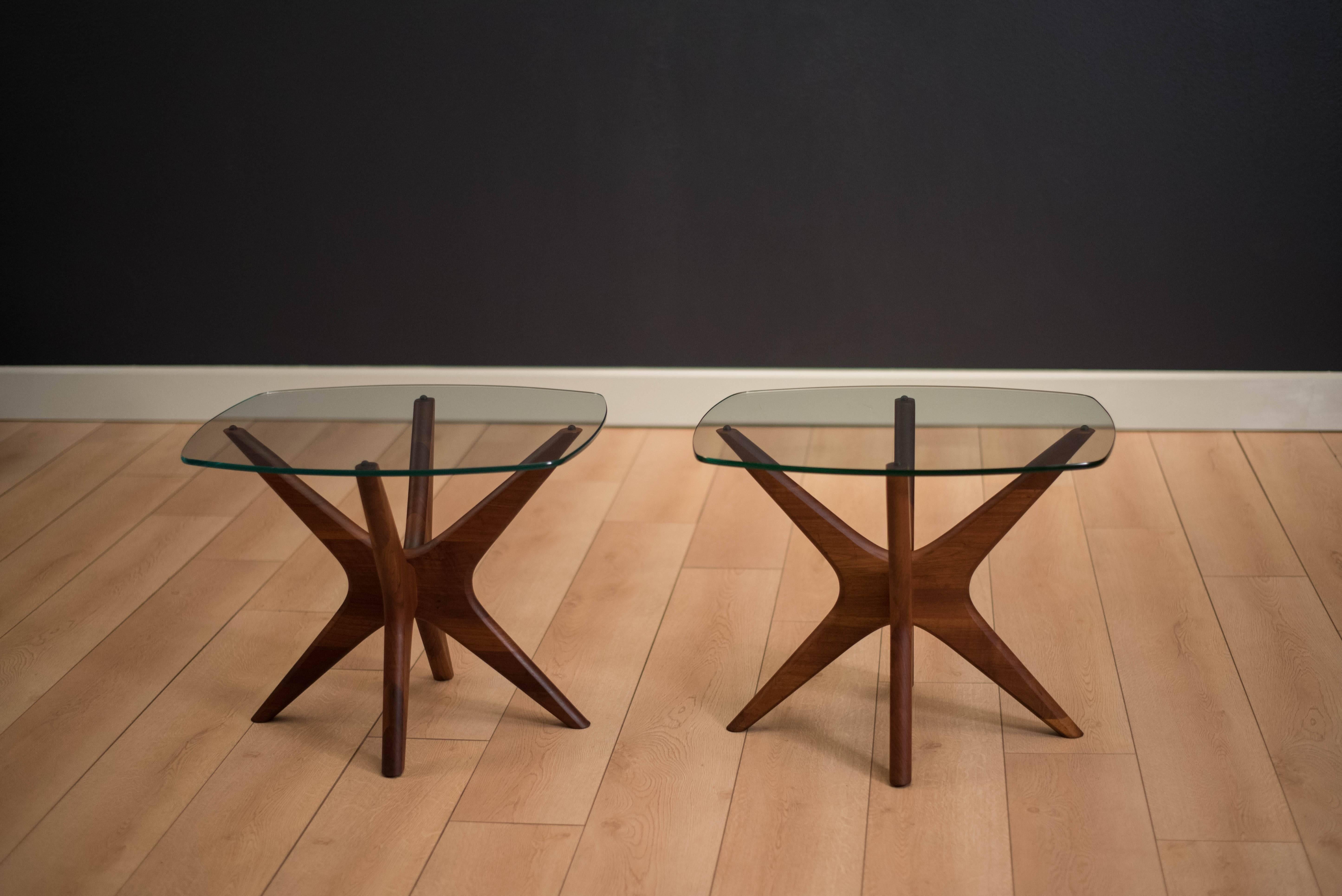 Mid-Century Modern 'Jacks' side tables designed by Adrian Pearsall for Craft Associates. This pair is made of solid sculpted walnut with a curved glass top. Price is for the pair.

