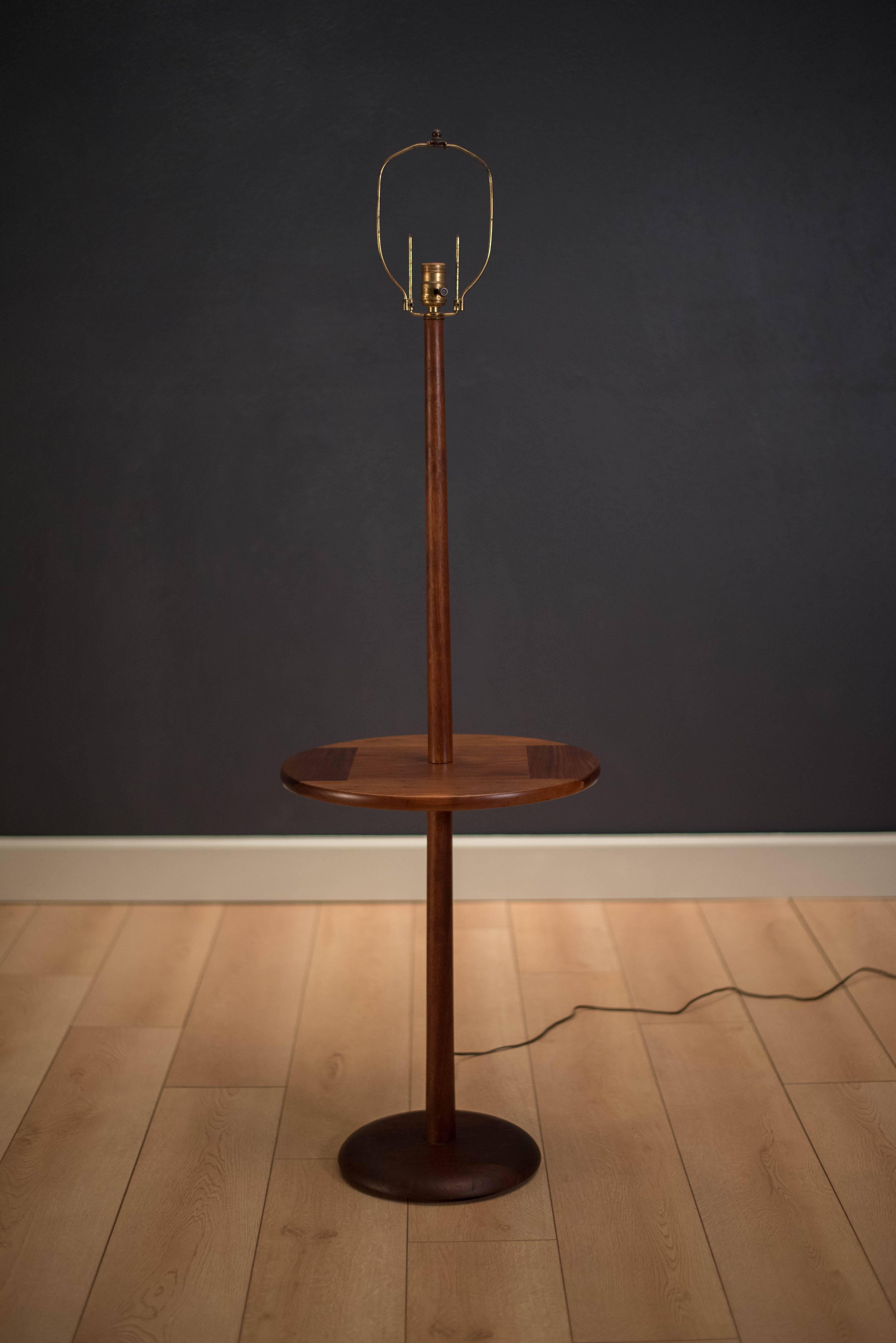 Vintage floor lamp with side table by Laurel Lamp Co. This piece is made of solid walnut and includes three-way switch.
