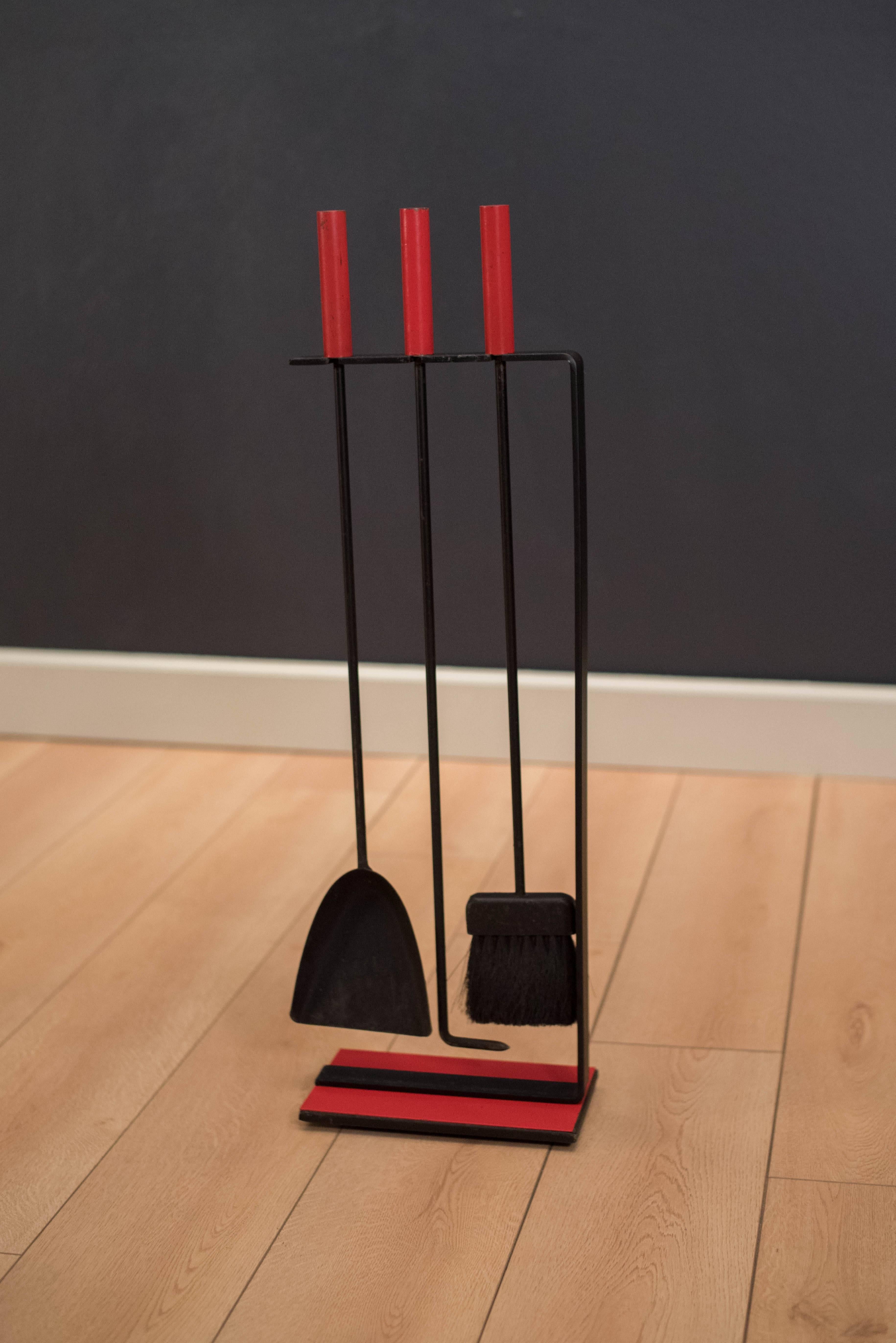 Mid-Century Modern fireplace tool set by Pilgrim. This set is made of cast iron with unique red enamel handles and base. Includes poker, shovel, and brush. 



