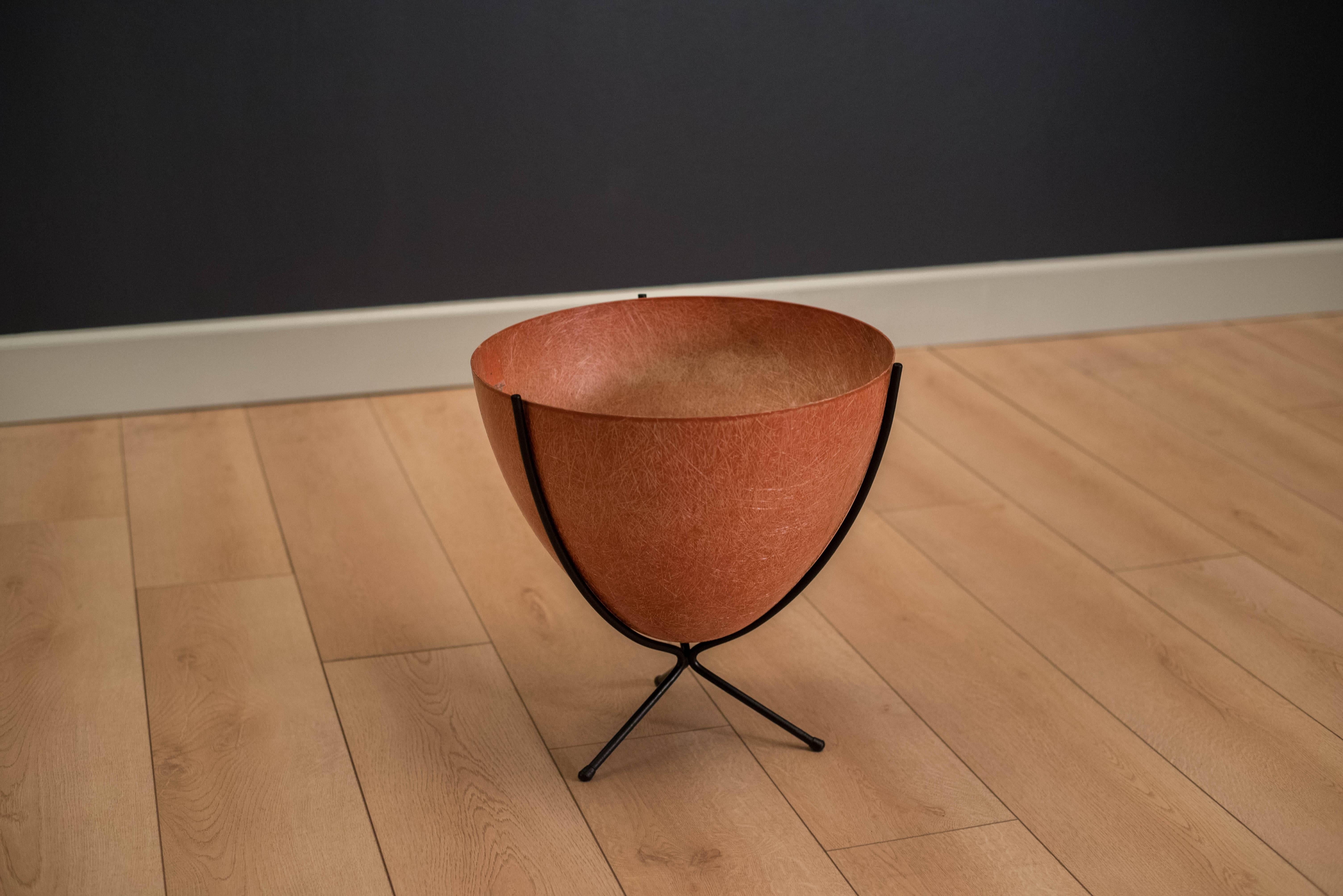 Vintage fiberglass bullet planter by Kimball Manufacturing Co. of San Francisco, circa 1960s. This piece comes in a vibrant orange color and black metal base.