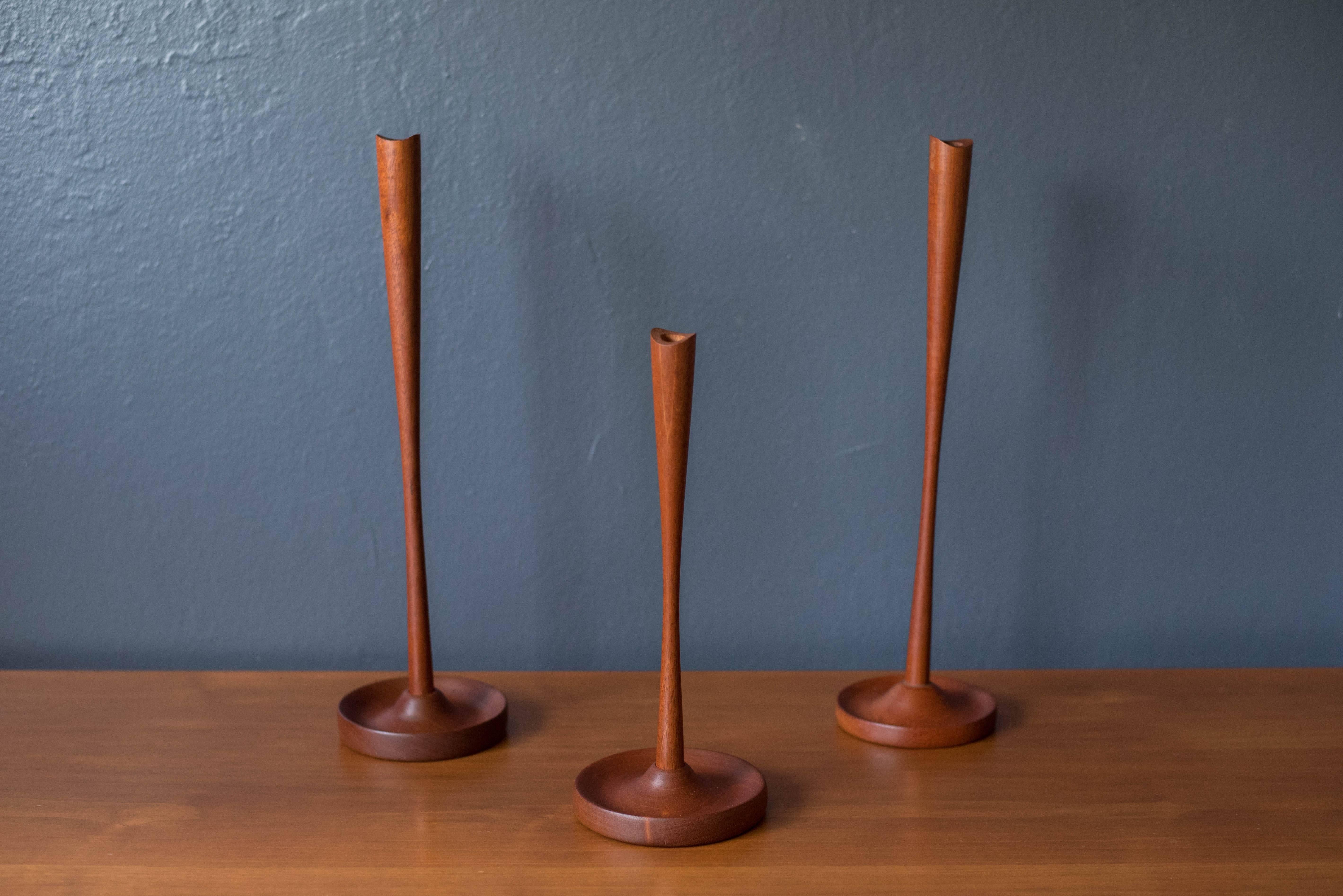 Mid-Century Modern candleholders in solid teak. This set has a unique carved shape and displays well with any modern decor. Price is for the set of three. 
 
Dimensions: 4