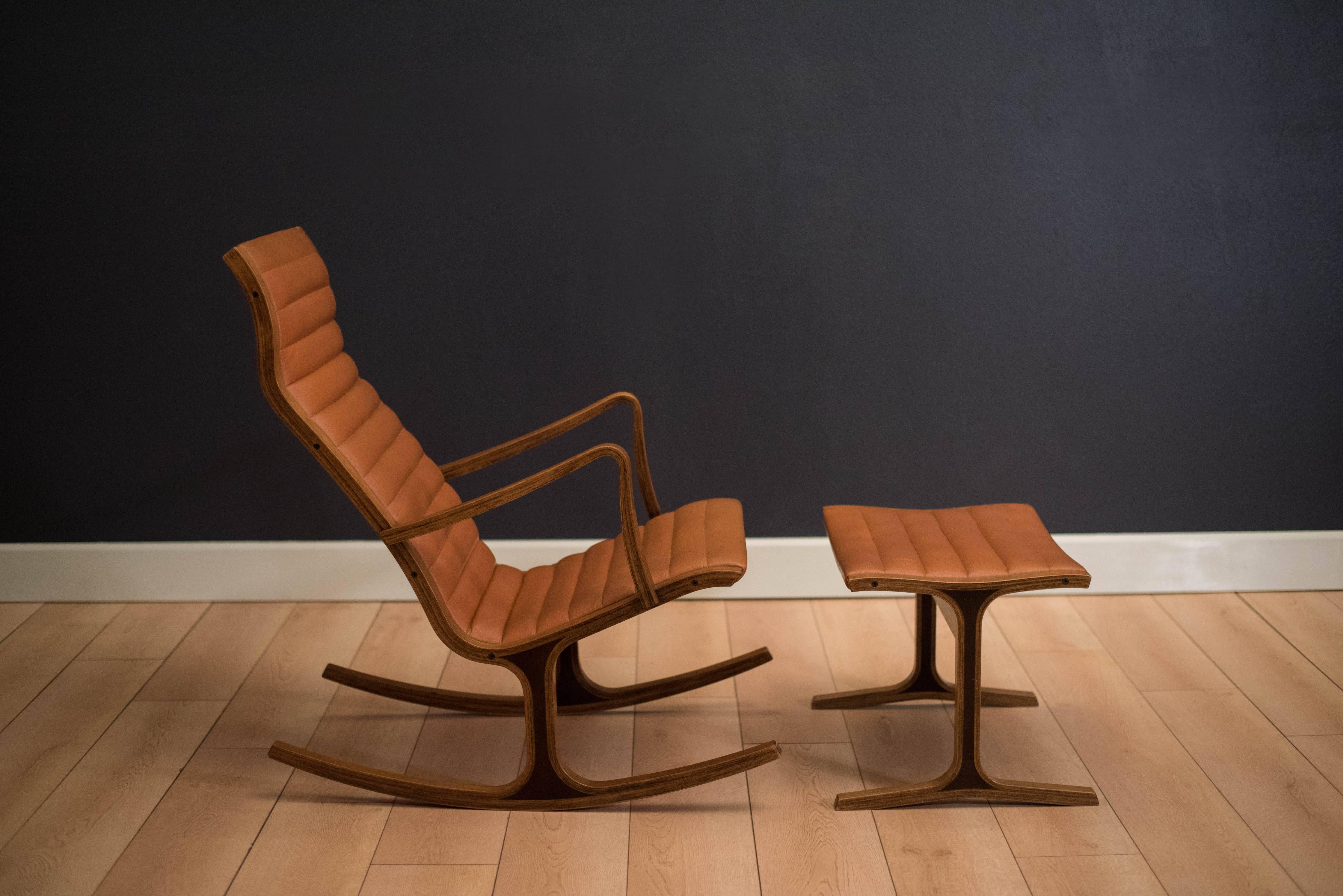 Mid-Century Modern Heron rocking chair designed by Mitsumasa Sugasawa for Tendo Mokko, Japan. This piece features an oak frame with stacked laminated ply and retains the original tan vinyl upholstery. Includes the matching ottoman. 

Measures: