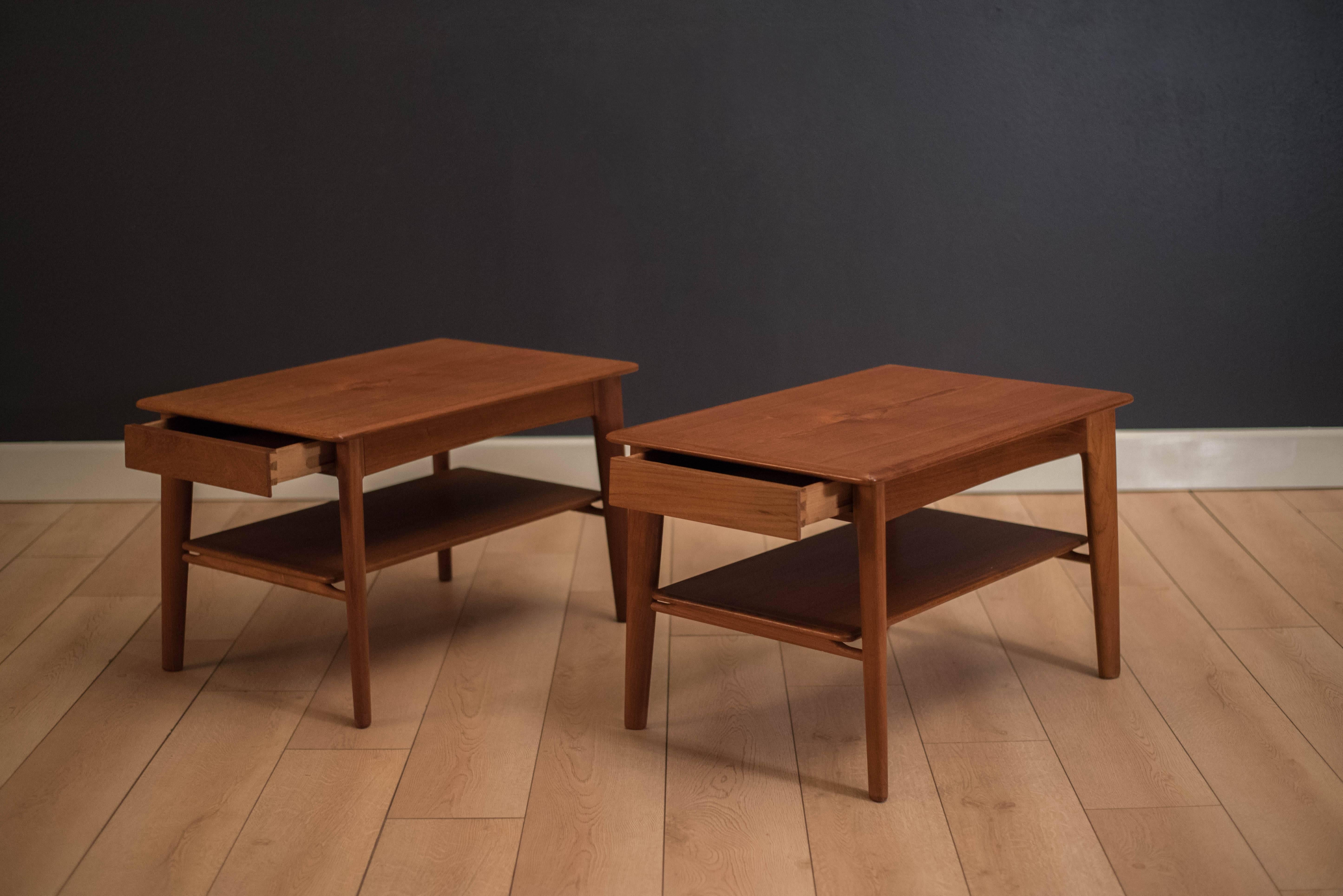Mid-Century Modern pair of two-tier side tables designed by Svend A. Madsen for Karl Lindegaard in teak. This set includes one drawer for additional storage. Price is for the pair.