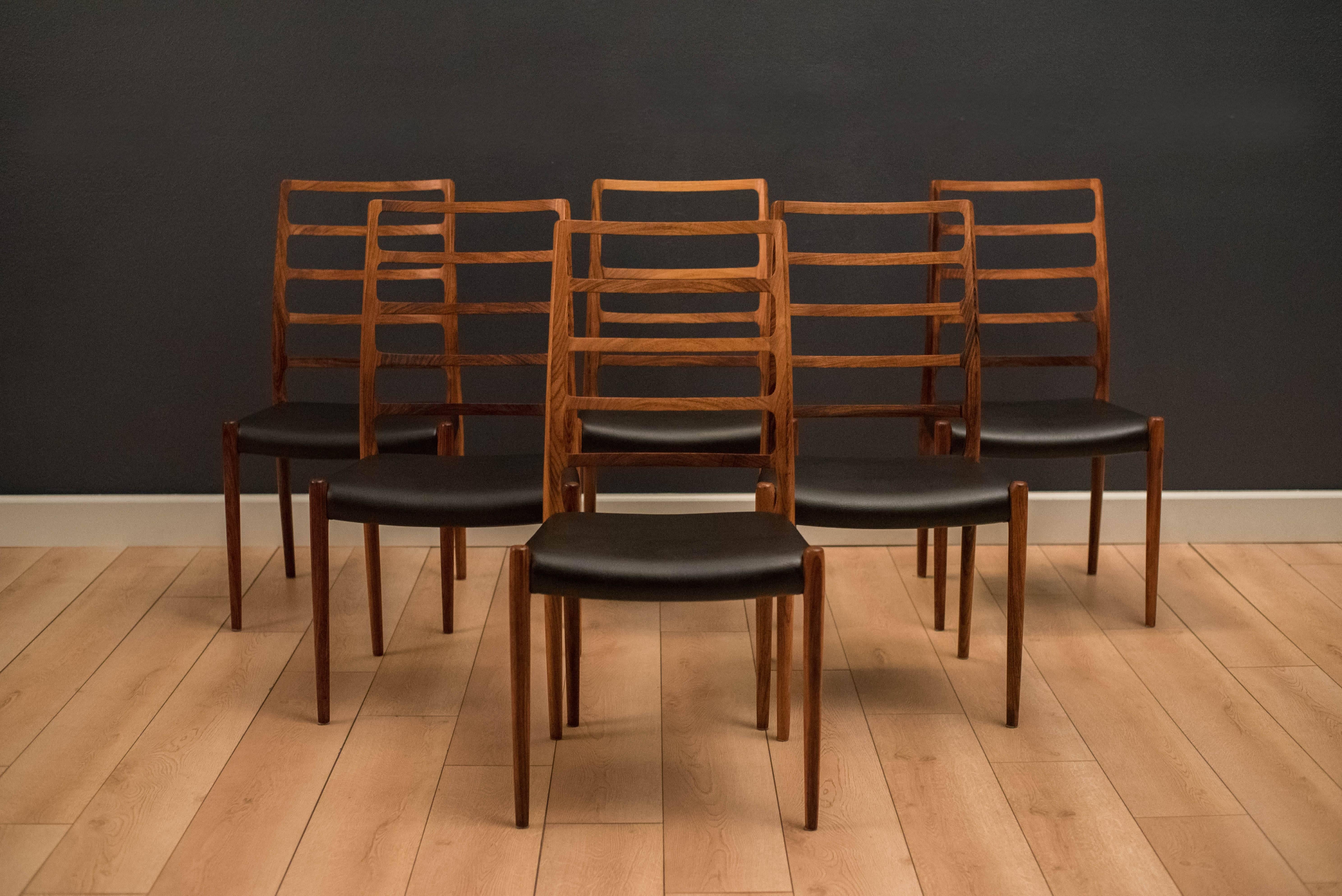 Danish Niels Otto Møller dining chairs model no. 82 in rosewood. This set of six displays stunning rosewood grains and original leatherette seats. Price is for the set of six chairs.