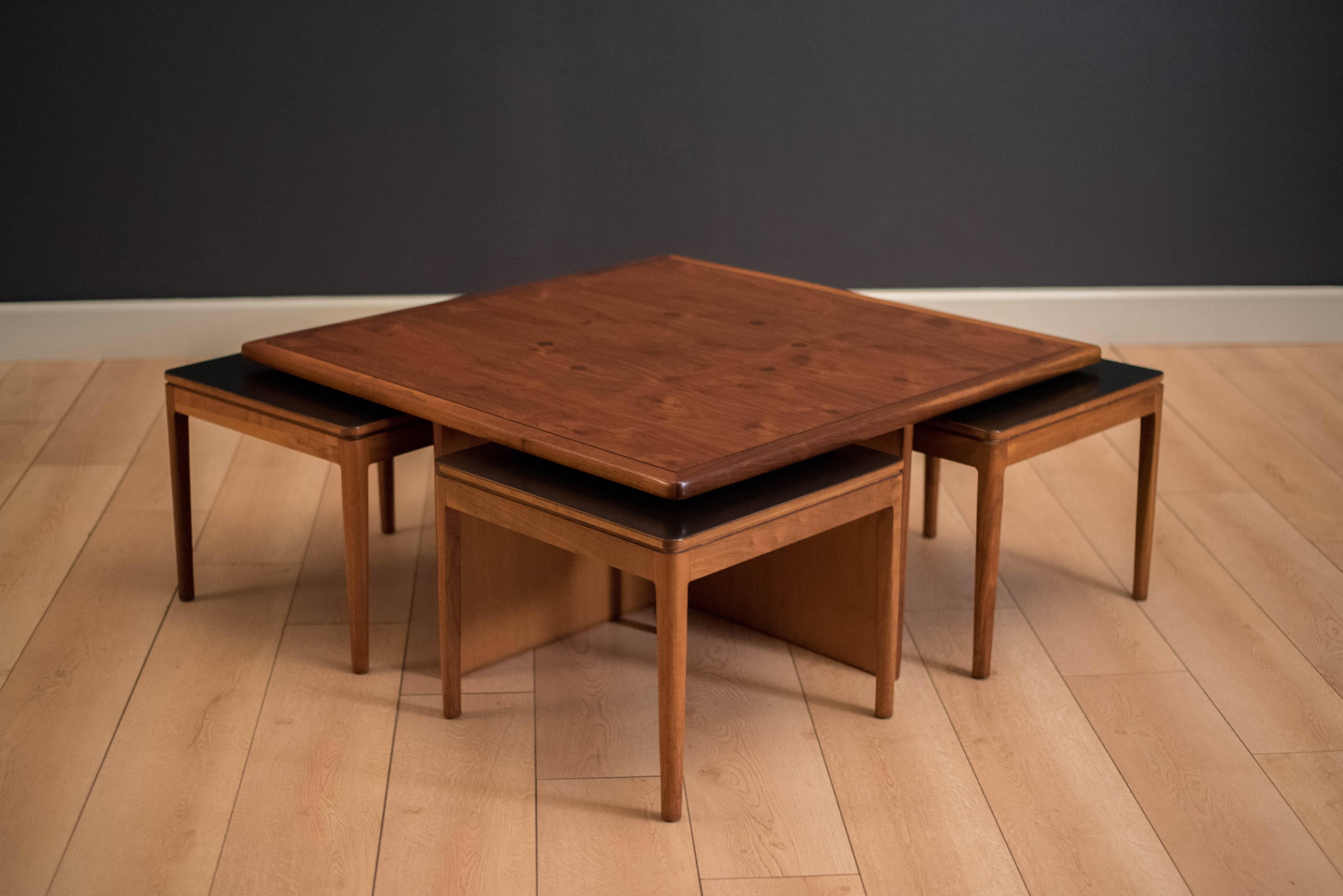 Vintage Drexel declaration coffee table by Kipp Stewart and Stewart McDougall in walnut. This unique piece features the line's signature rosewood inlay on tabletop. Includes four tables or stools with black formica tops. 

Measures: Small tables: