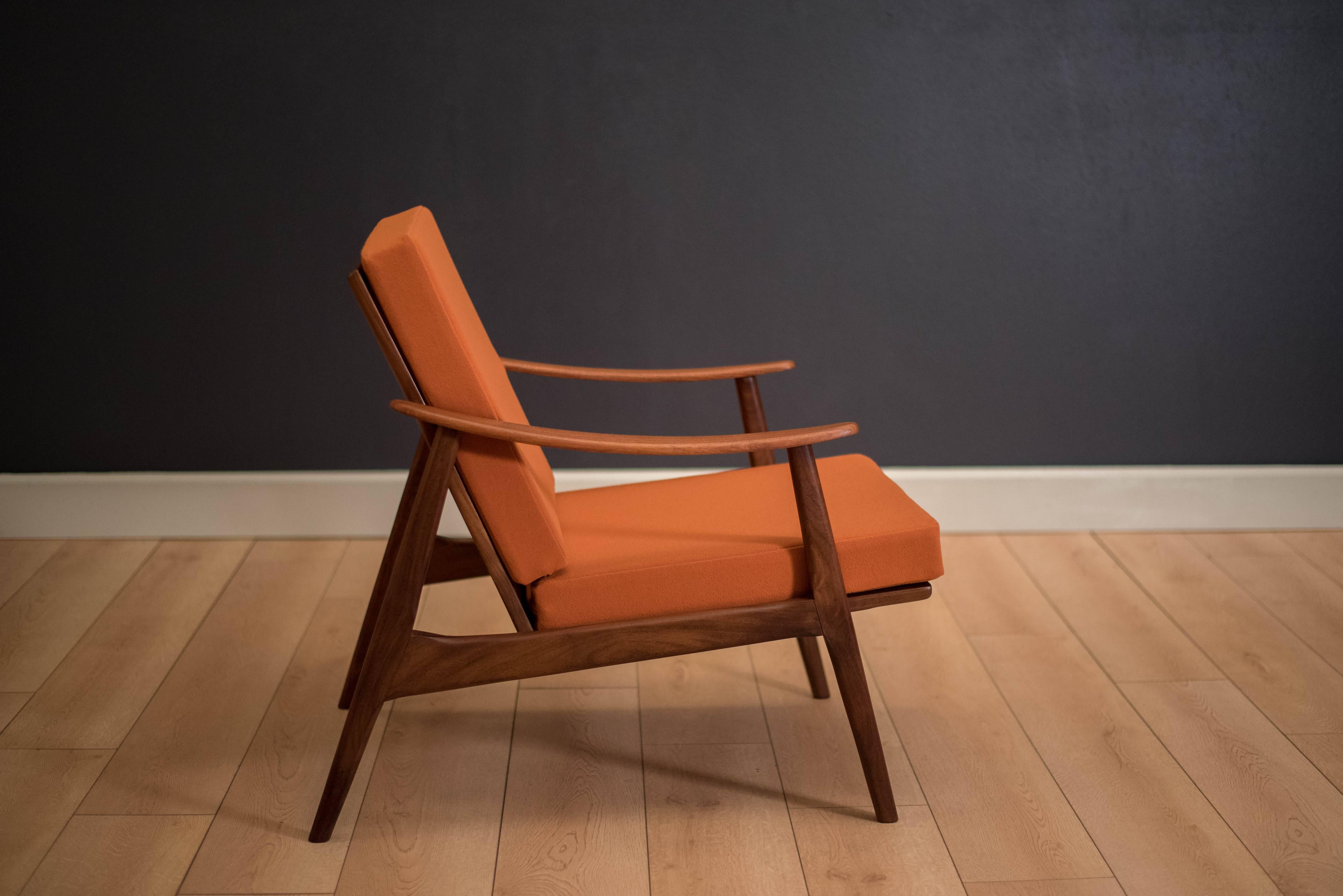 Mid-Century Modern lounge chair in teak, circa 1960s. This piece has been reupholstered with brand new foam and webbing in a vintage dead stock fabric.