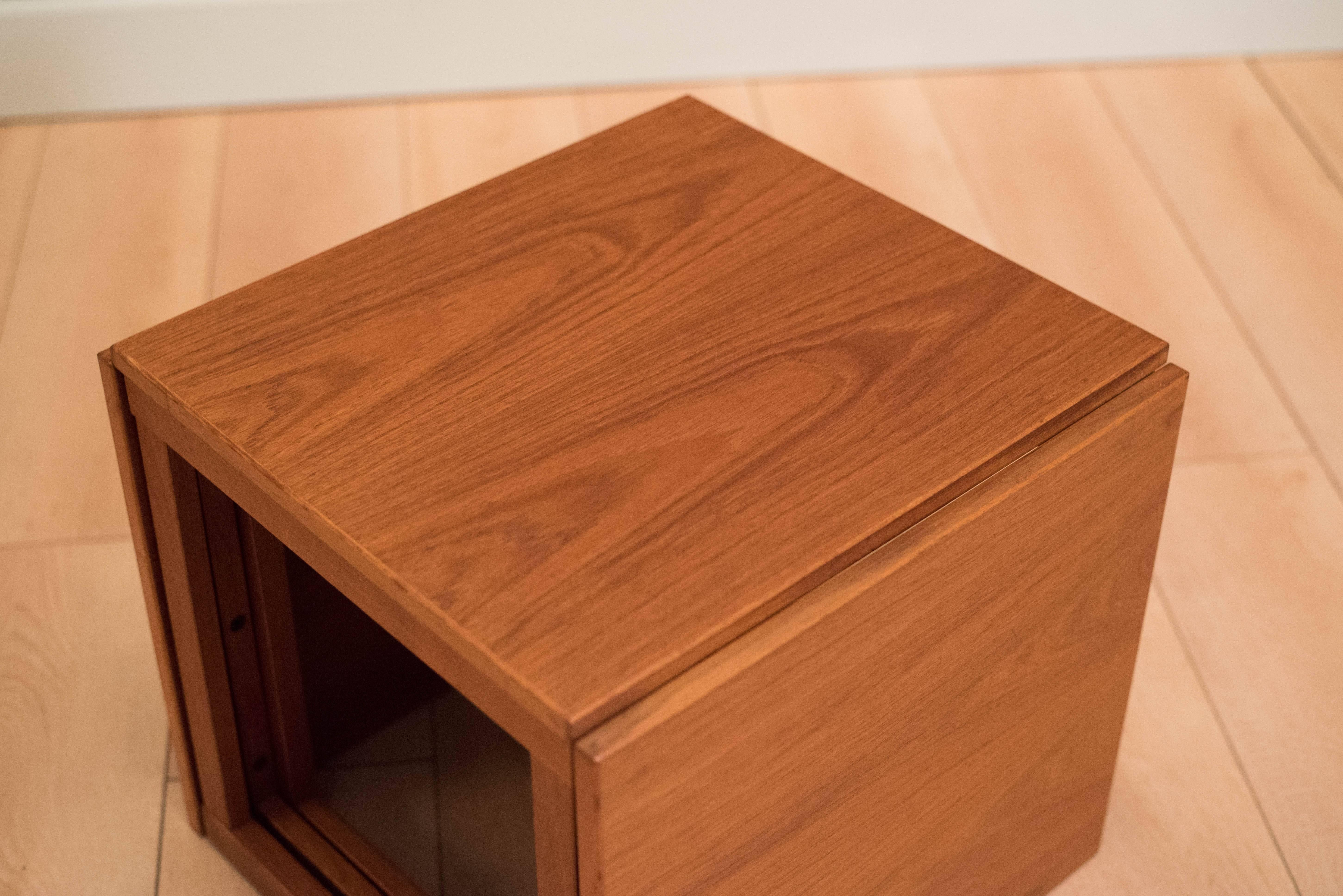 Mid-Century teak nesting tables designed by Kai Kristiansen. This set includes three end tables that can be used separately or cleverly store as a cube.