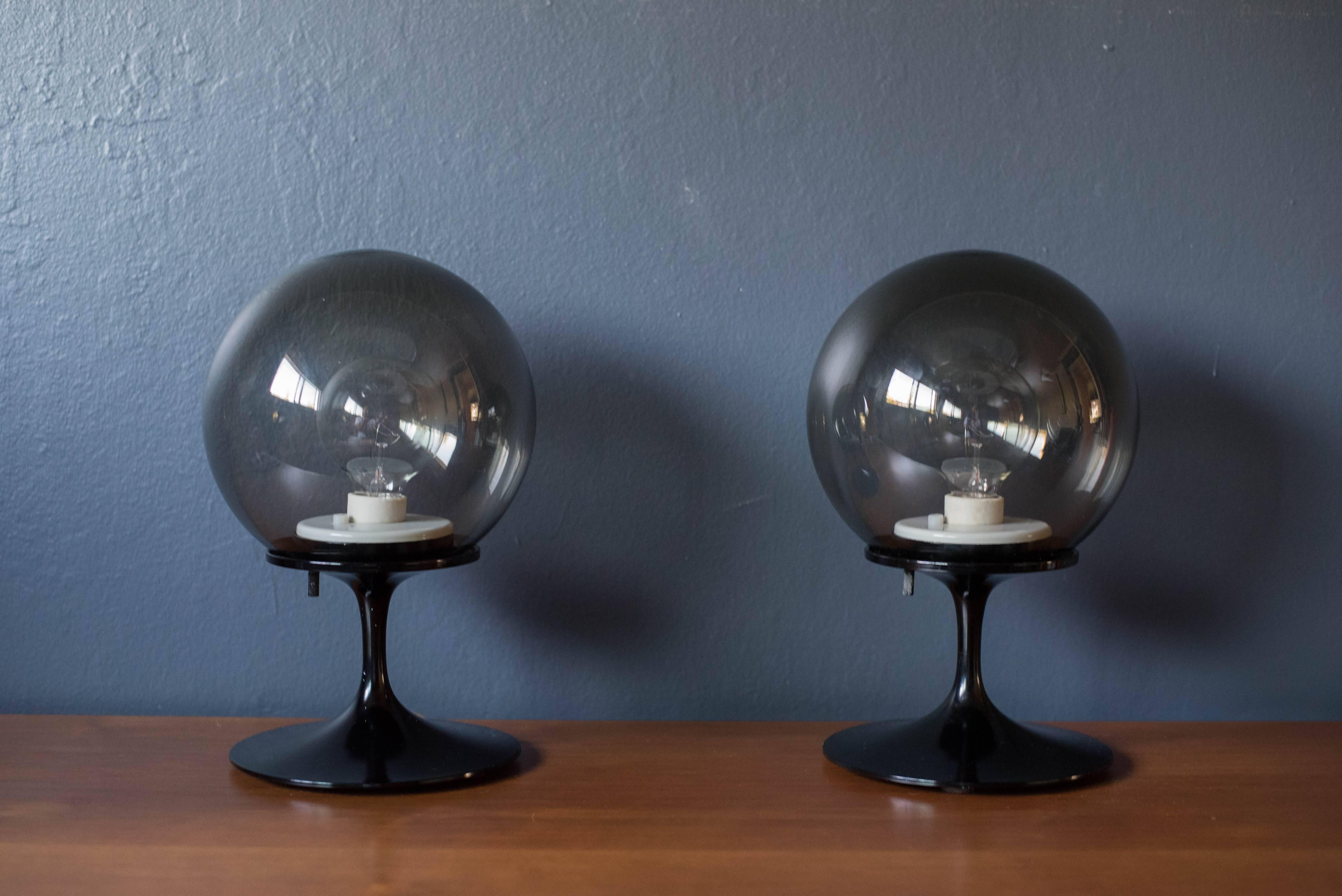Vintage pair of stemlite lamps by Bill Curry for Design Line. This set features smoked glass globes and a tulip base with black enamel finish.



Offered by Mid Century Maddist