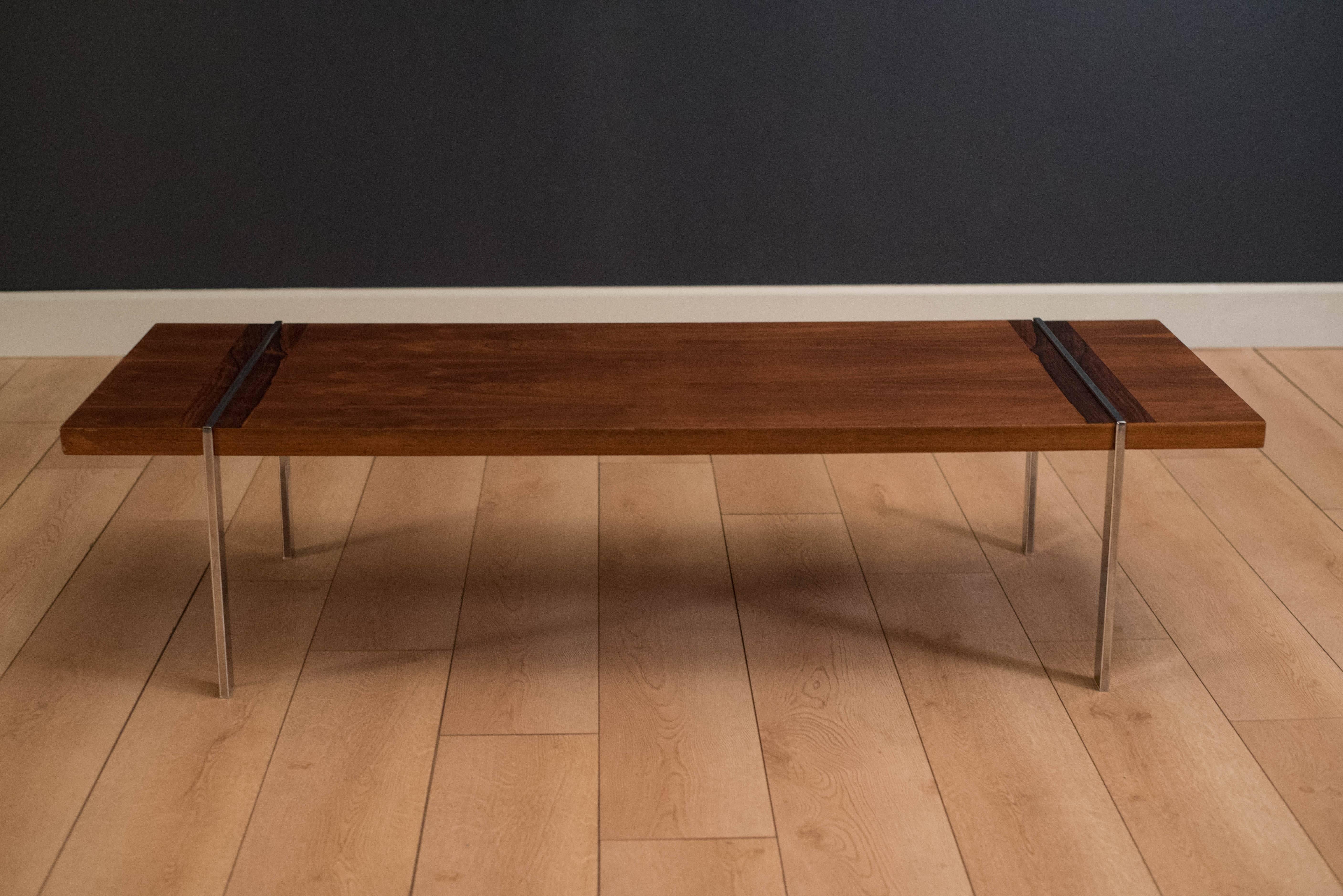 Midcentury coffee table manufactured by Lane in walnut. This piece has a unique chrome base with rosewood accents.
