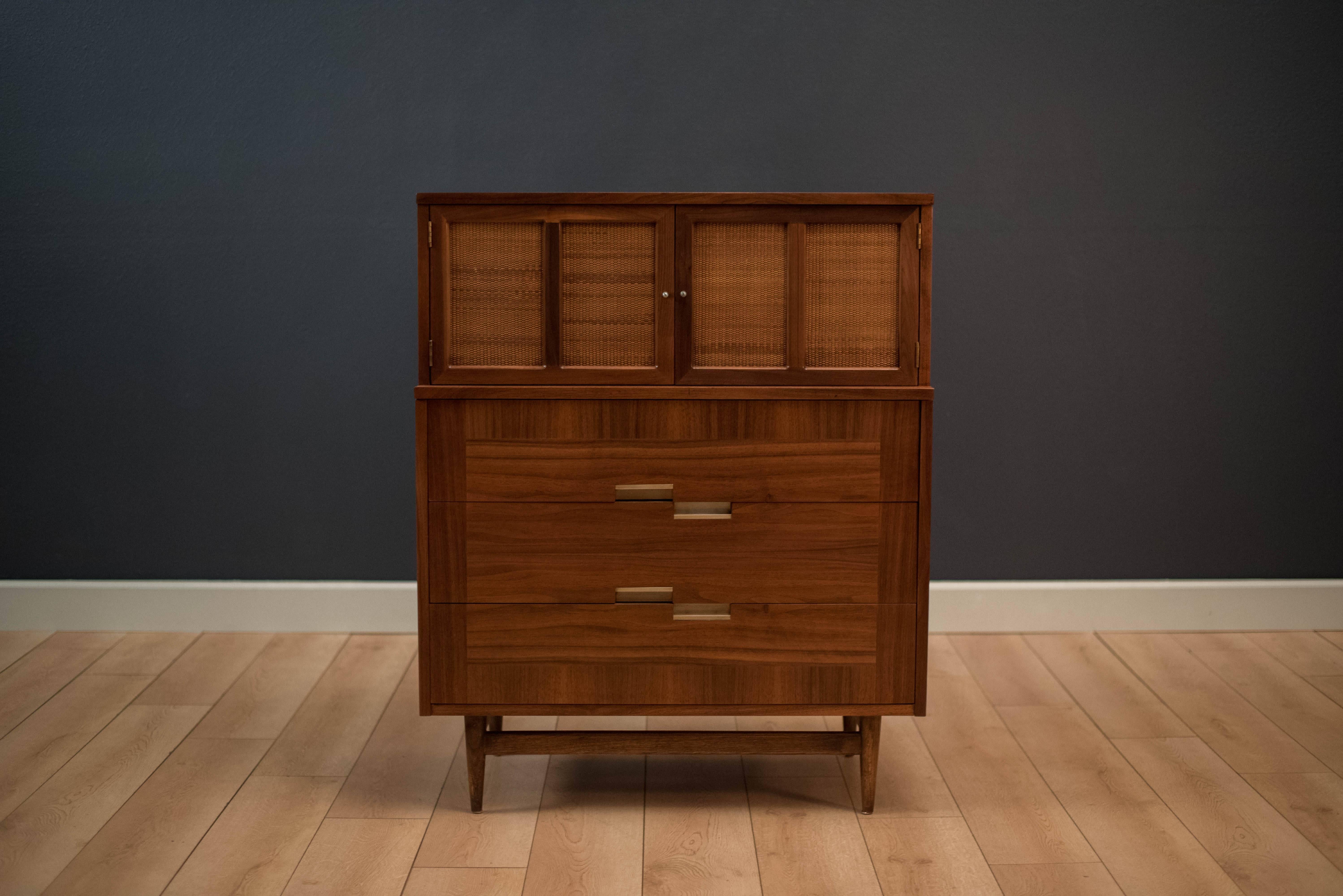 Midcentury Highboy dresser by American of Martinsville in walnut. This piece includes five spacious drawers with picture frame opposing wood veneers. Features the line's signature aluminium handles and X inlay.