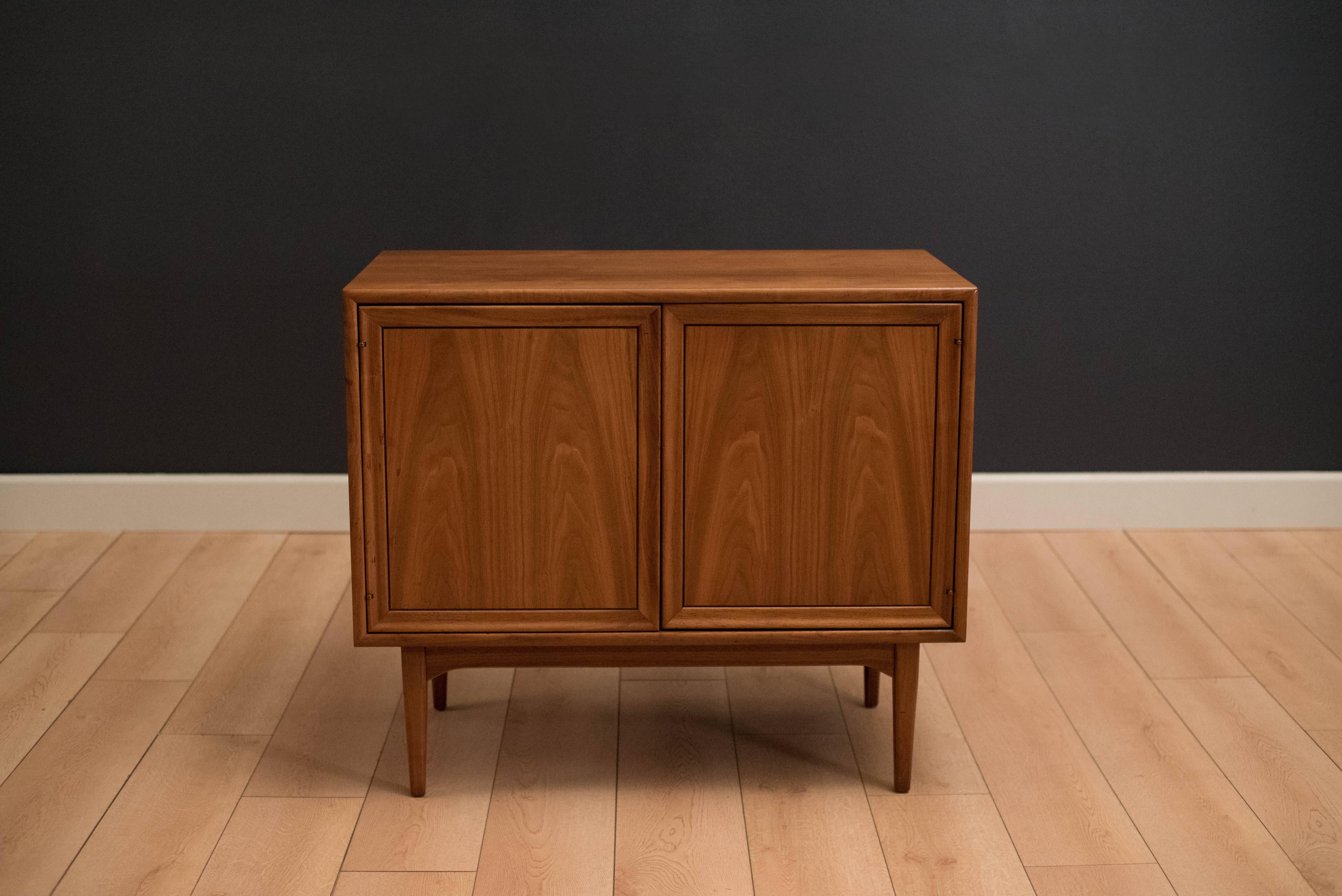 Mid-Century Modern record cabinet designed by Stewart McDougall and Kipp Stewart for Drexel. This piece includes one fixed top shelf with adjustable vertical dividers.