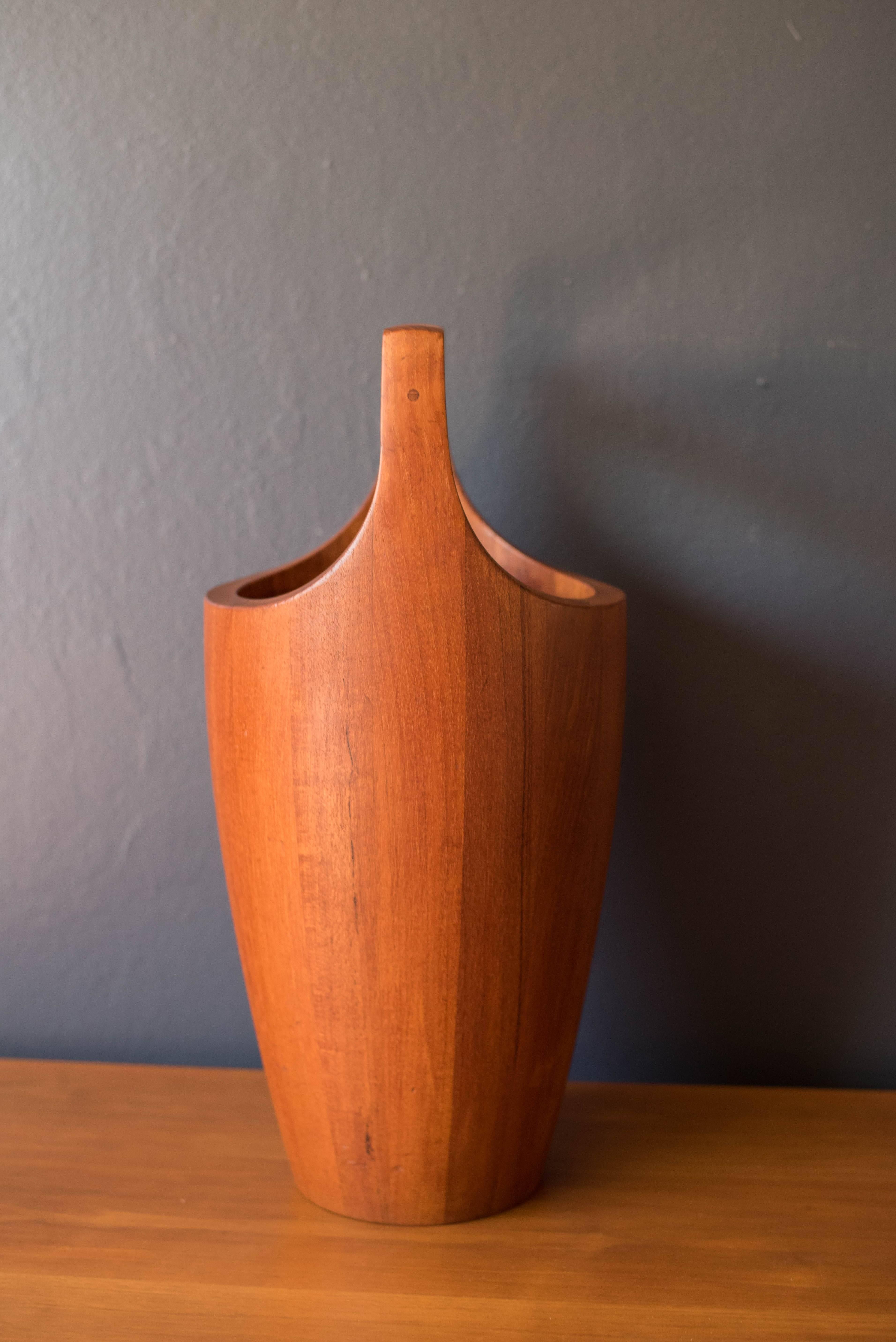 Mid century Dansk Congo ice bucket wine cooler in teak designed by Jens H. Quistgaard. This collectible piece is made of solid teak and includes the original black plastic interior liner. The perfect decorative accessory to add to any home bar or