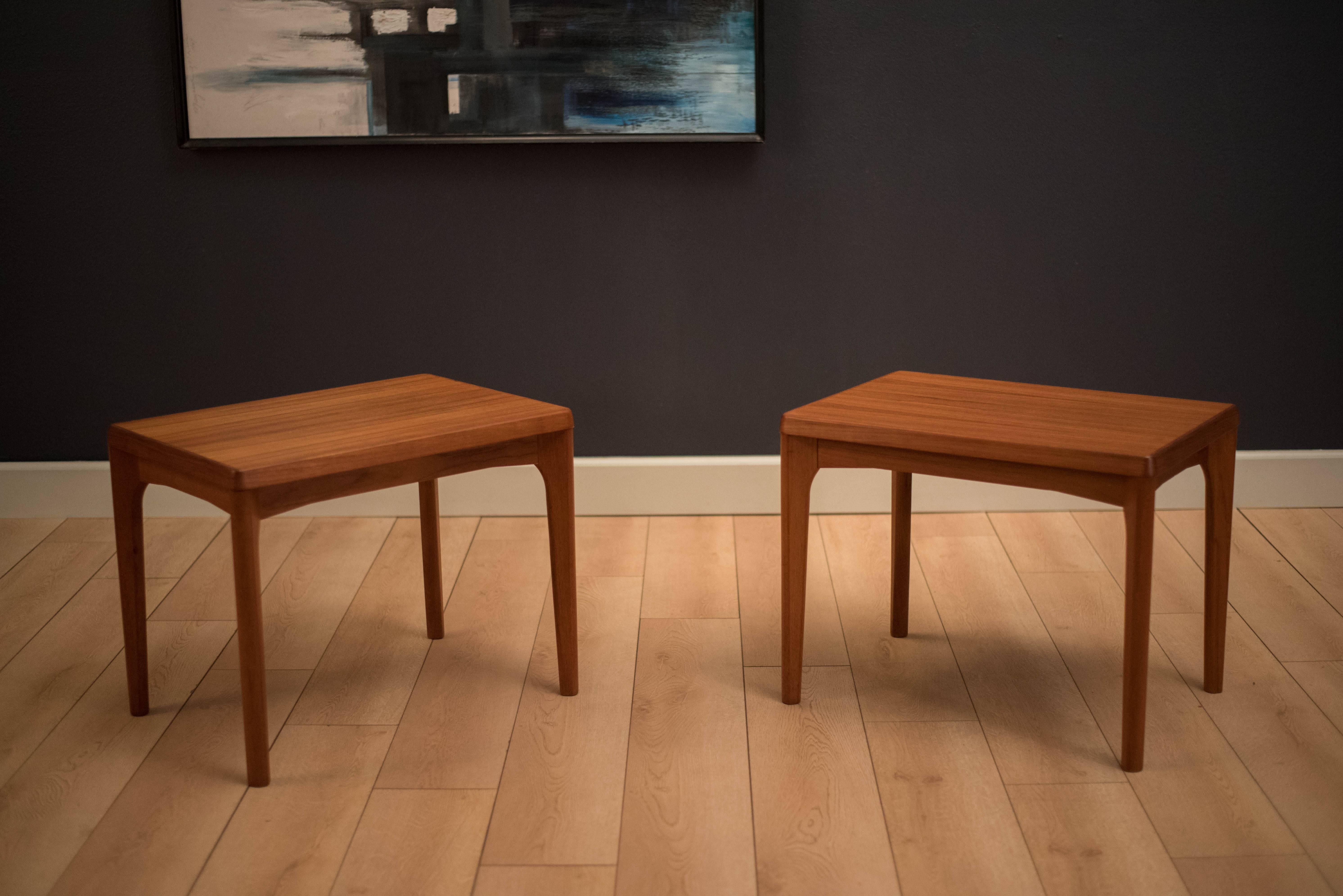 Midcentury pair of side tables designed by Henning Kjaernulf for Vejle Stole-og Mobelfabrik in teak. This set features sculptural edges and sleek angled tapered legs. Price is for the pair.