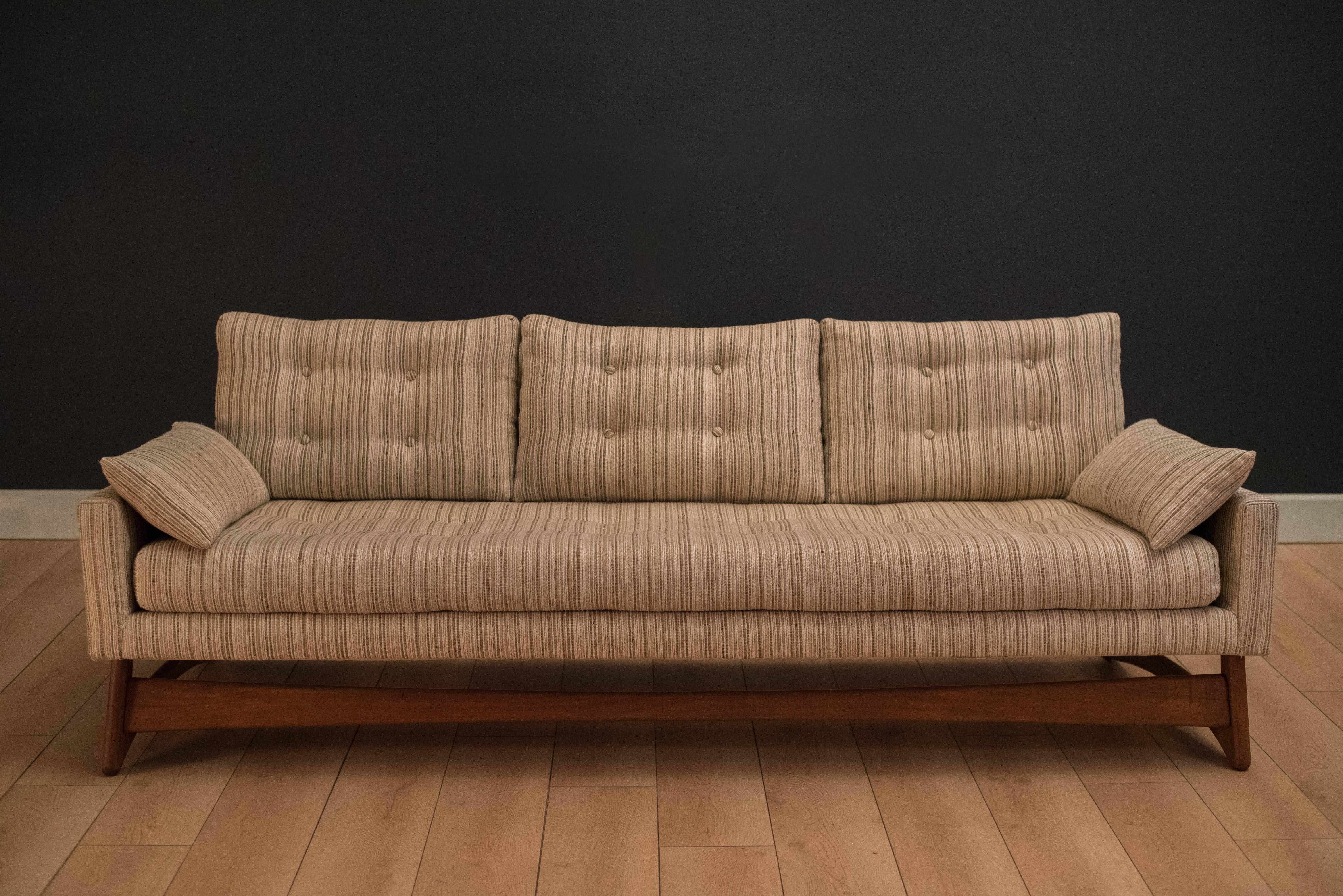 Mid-Century Modern sofa designed by Adrian Pearsall for Craft Associates Inc. This piece features the iconic sculptural walnut base and interwoven blends of ivory and neutral upholstery.