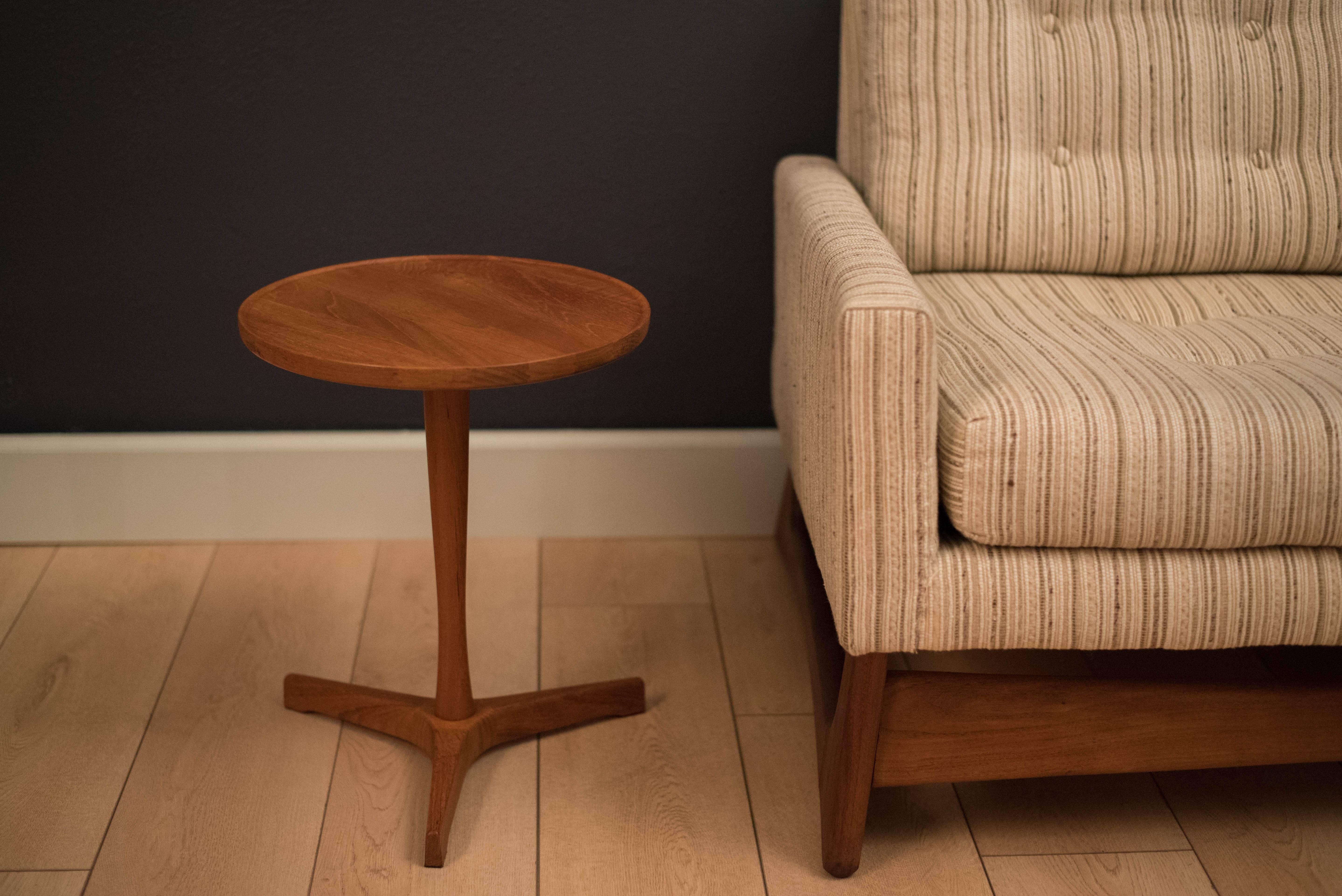 Mid-Century Modern teak side table designed by Hans C. Andersen for Artex. This piece has a round tabletop and a solid teak pedestal base.