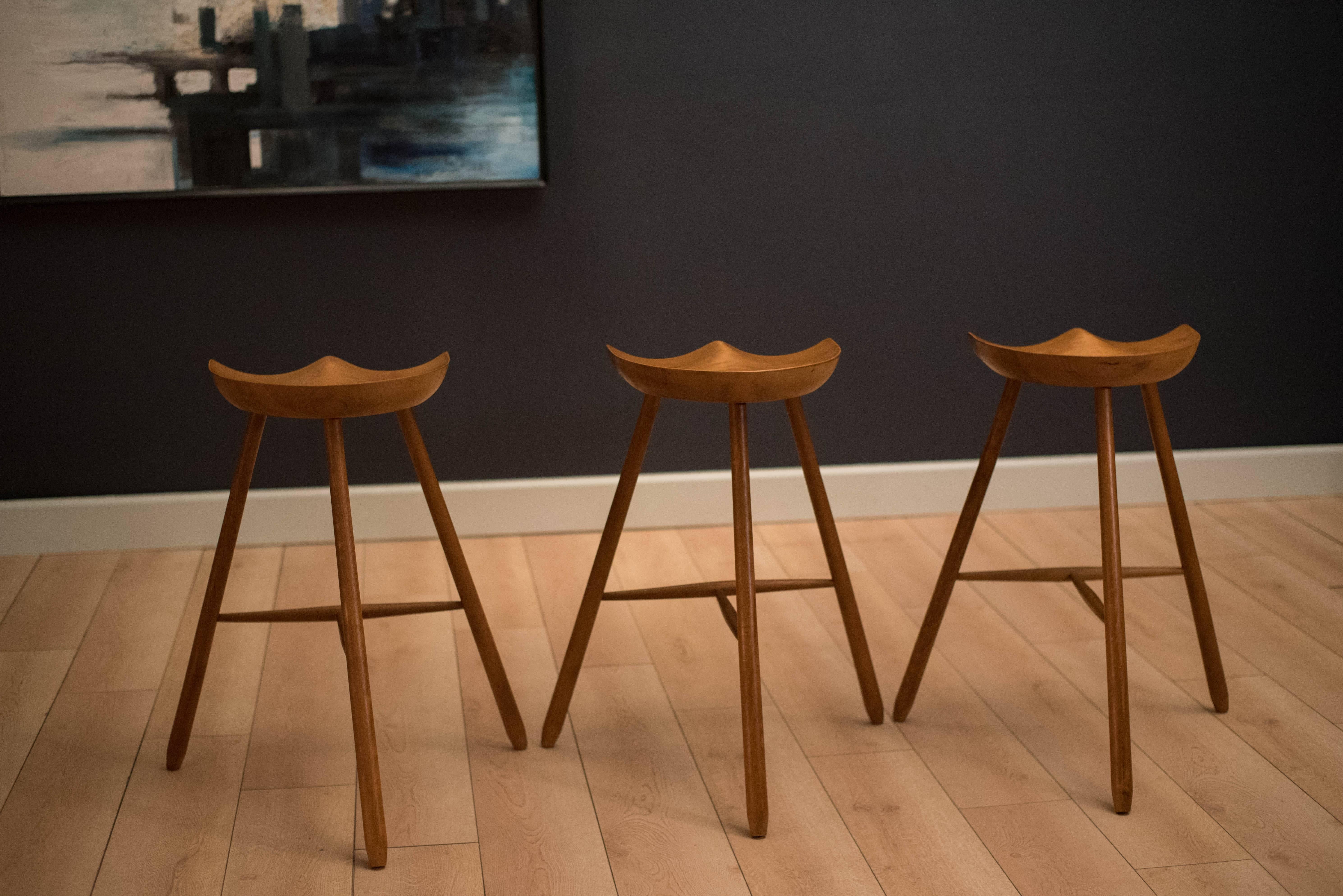 Vintage set of three counter stools in the manner of Mogens Lassen. This set features sculptural wood framed seats with a three legged base. 

Seat: 15.25