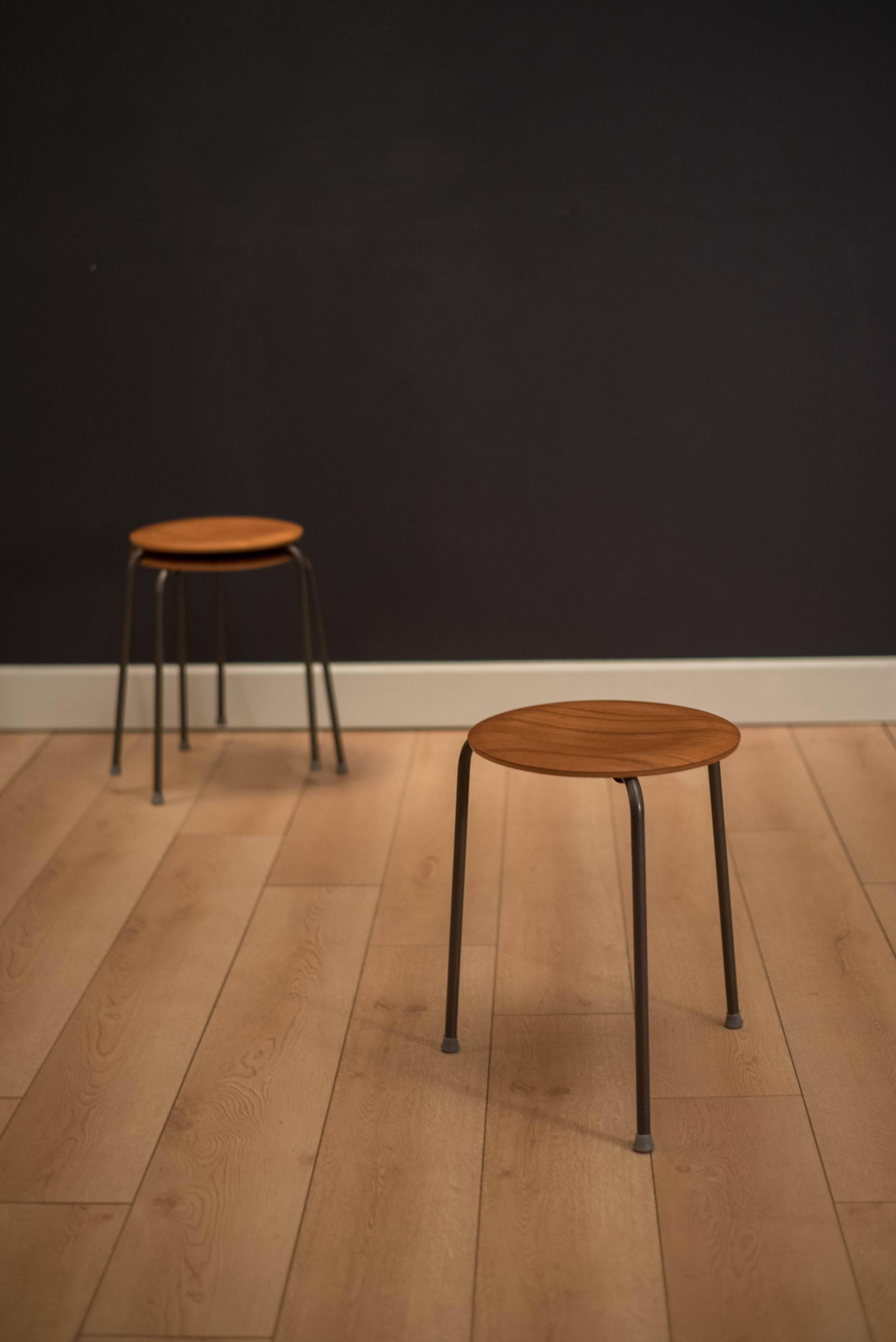 Mid century set of three dot stools by Arne Jacobsen for Fritz Hansen. This stackable collection features a curved teak tabletop and the original three legged base. 

measures: Top 13