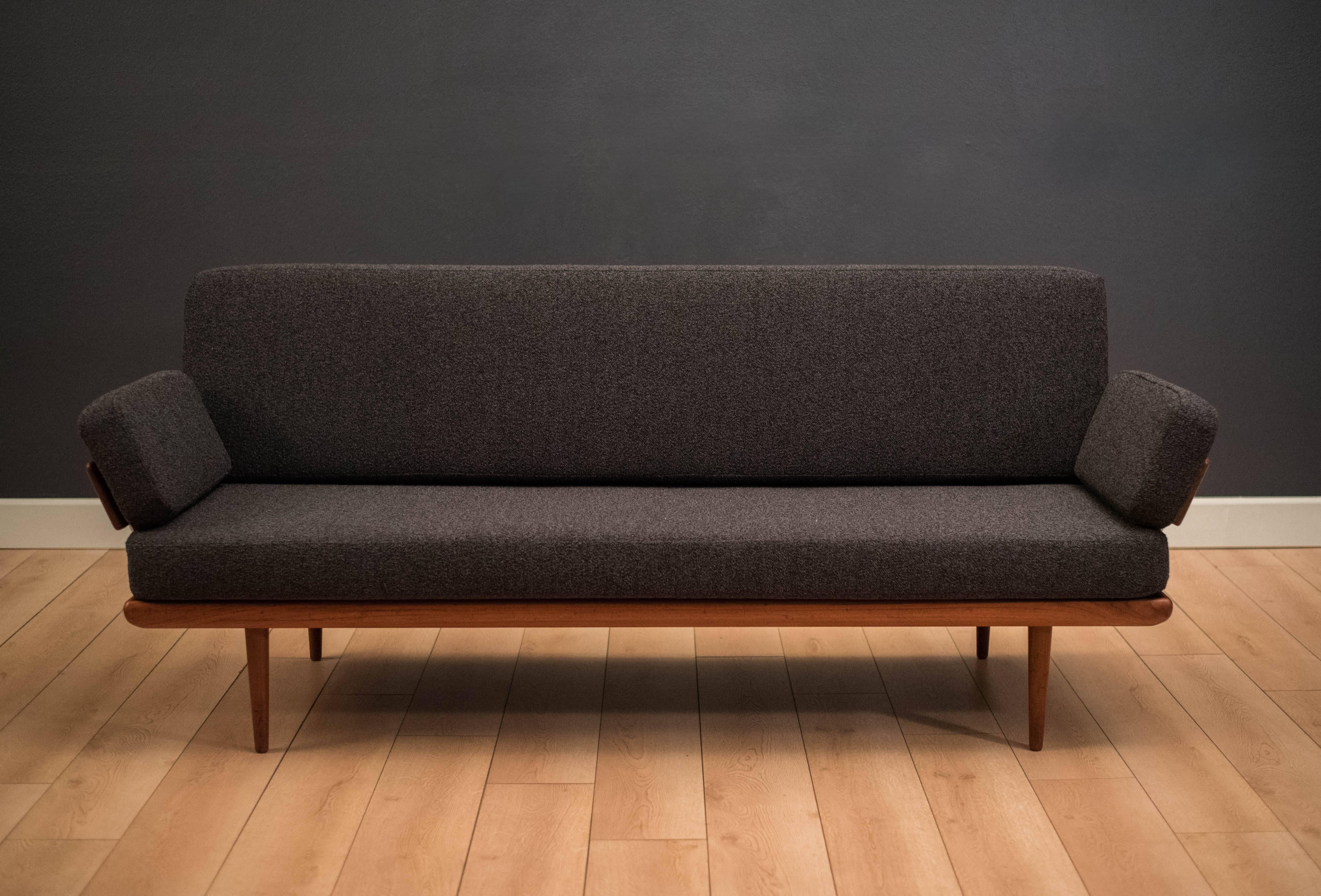 Mid-Century Modern sofa designed by Peter Hvidt and Orla Mølgaard-Nielsen for France & Son Daverkosen. This piece features a unique sculpted teak frame with chrome accents. It has been professionally reupholstered in a charcoal gray Maharam fabric