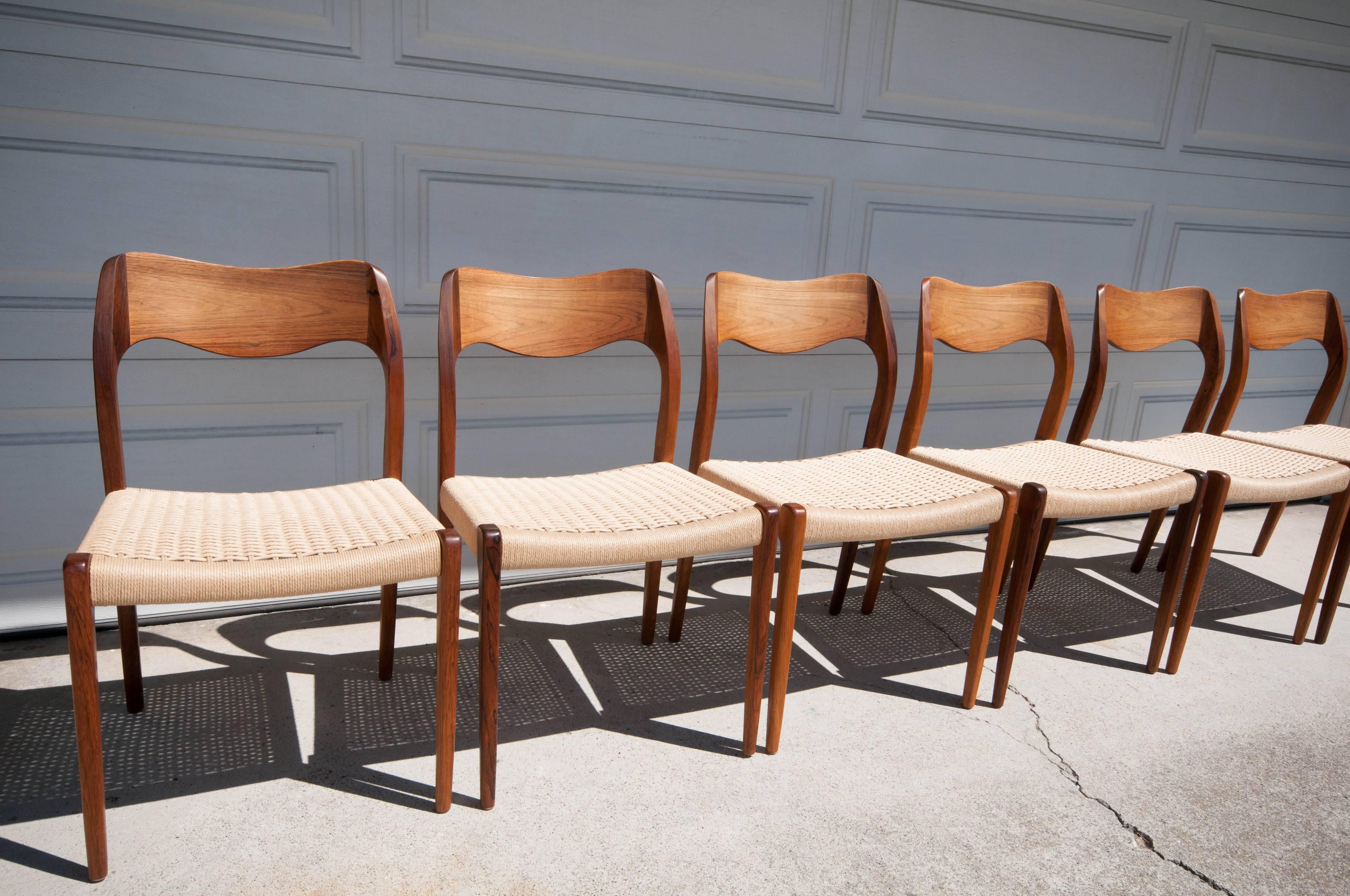 Danish Niels Moller 71 Dining Chairs in Brazilian Rosewood. This set of six and has brand new paper cord seating and stunning rosewood grains.  Price is for the set of six chairs.