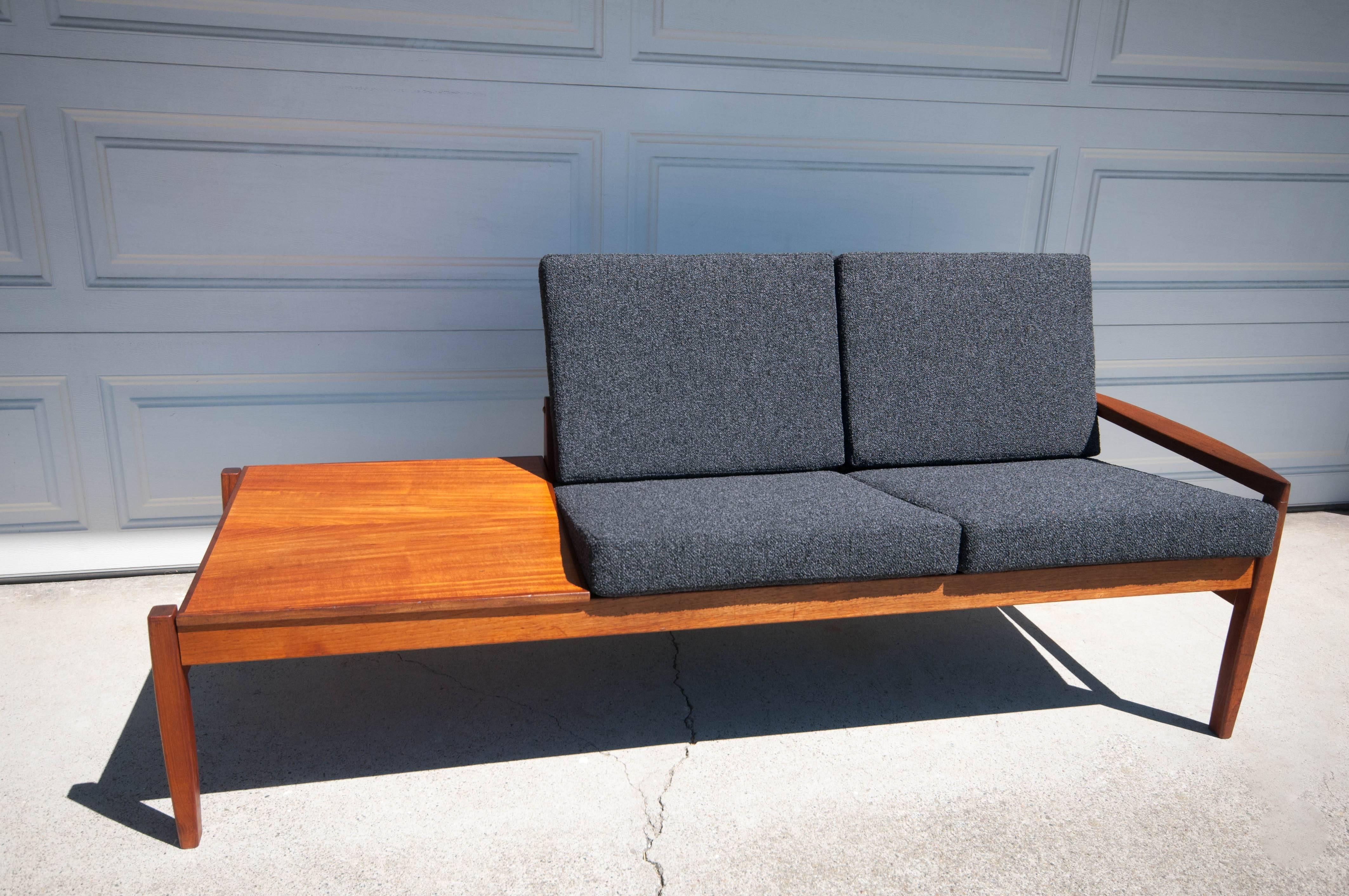 Danish Modular Sofa Set by Hans Olsen in teak. This piece features one end table and two caned back seats that can be arranged in any order. Seats have been newly reupholstered in a charcoal gray Maharam Kvadrat fabric.