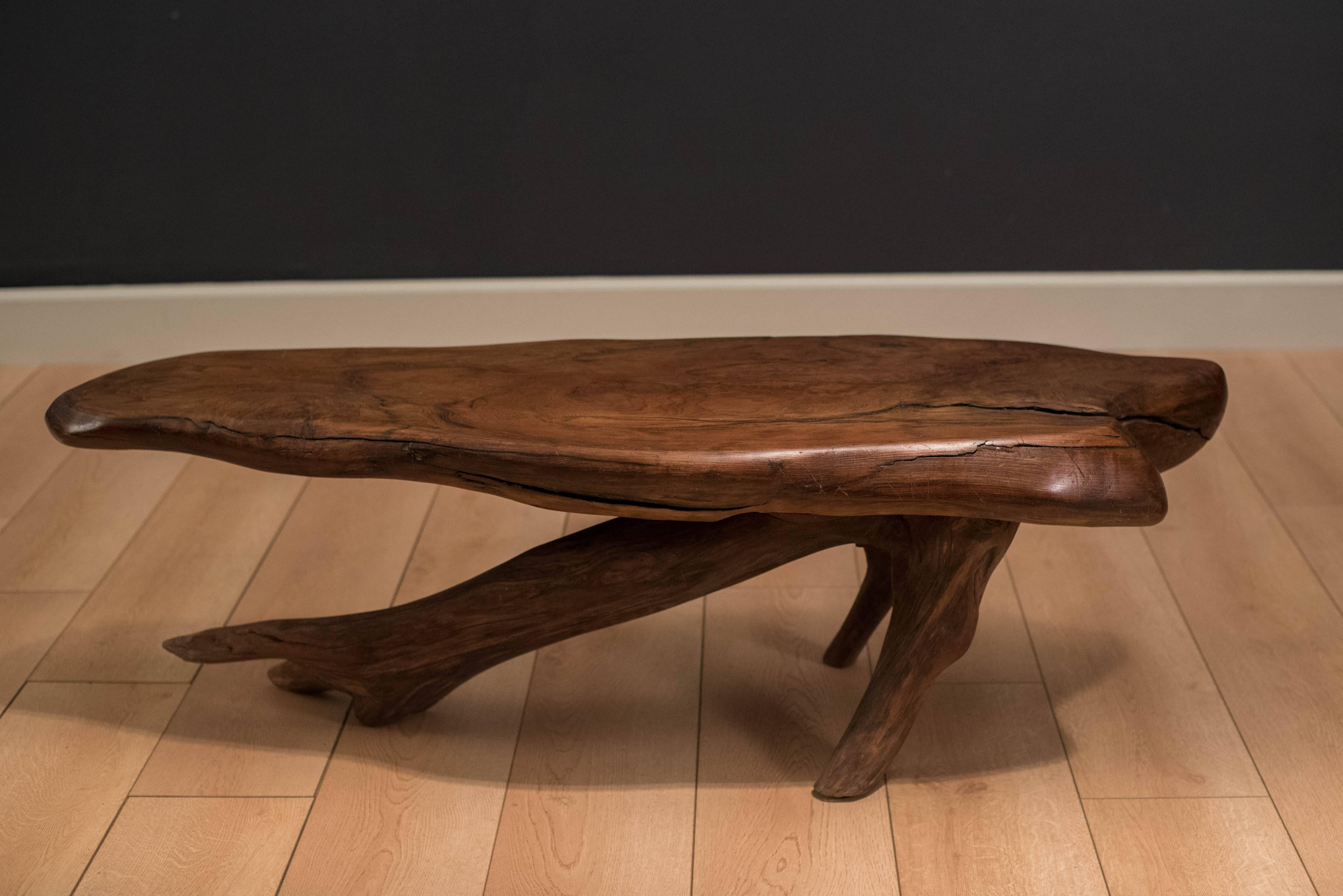 Mid-Century redwood coffee table with live edge, circa 1960s. This solid piece has a unique free-form tabletop and base. Features natural flowing wood grains.