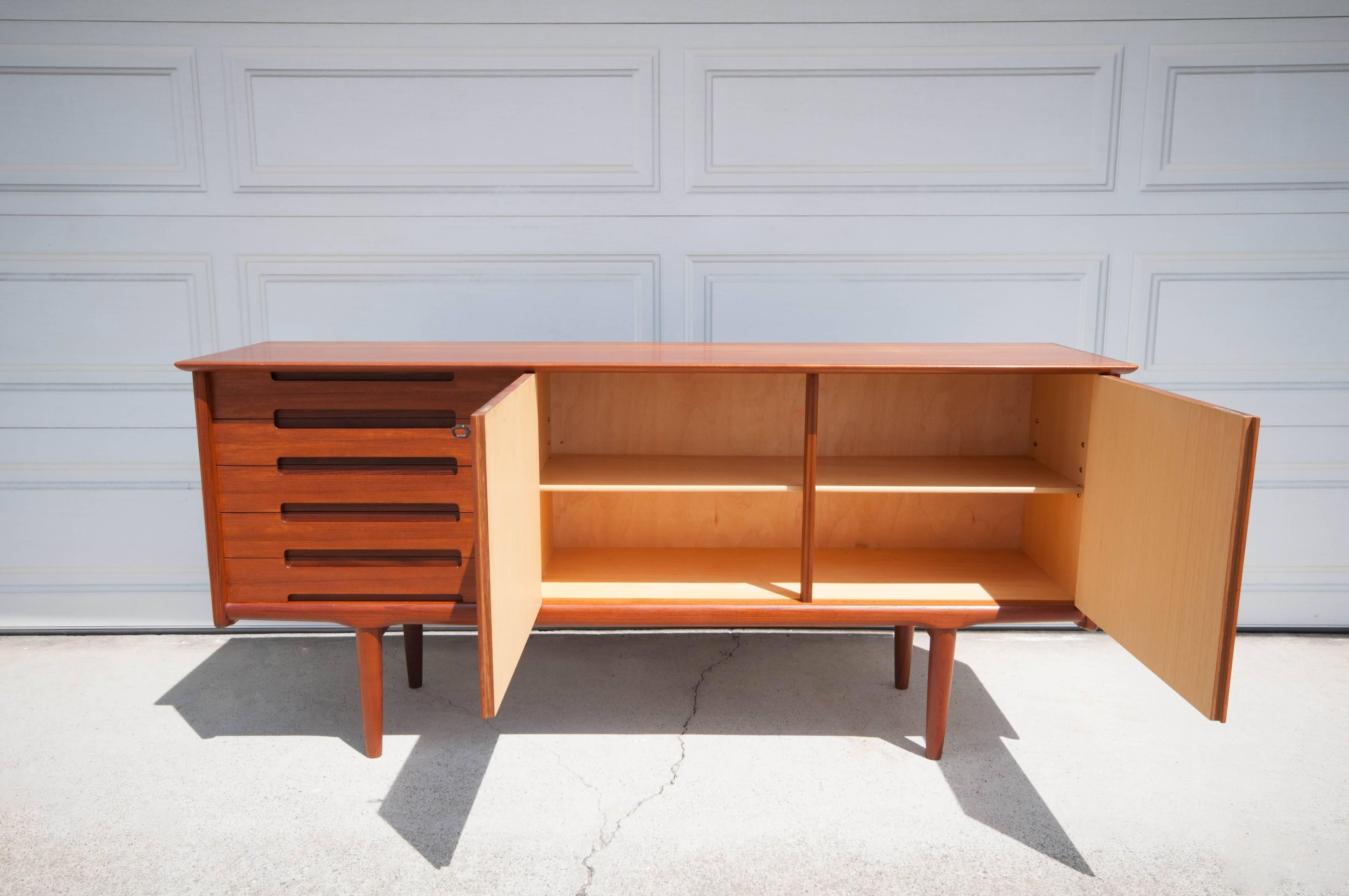 Mid-Century Sideboard marked Brodrene Sorheim, Norway designed by Arnt Sorheim. This piece displays beautiful teak craftsmanship that provides five drawers and open storage space with adjustable shelving.