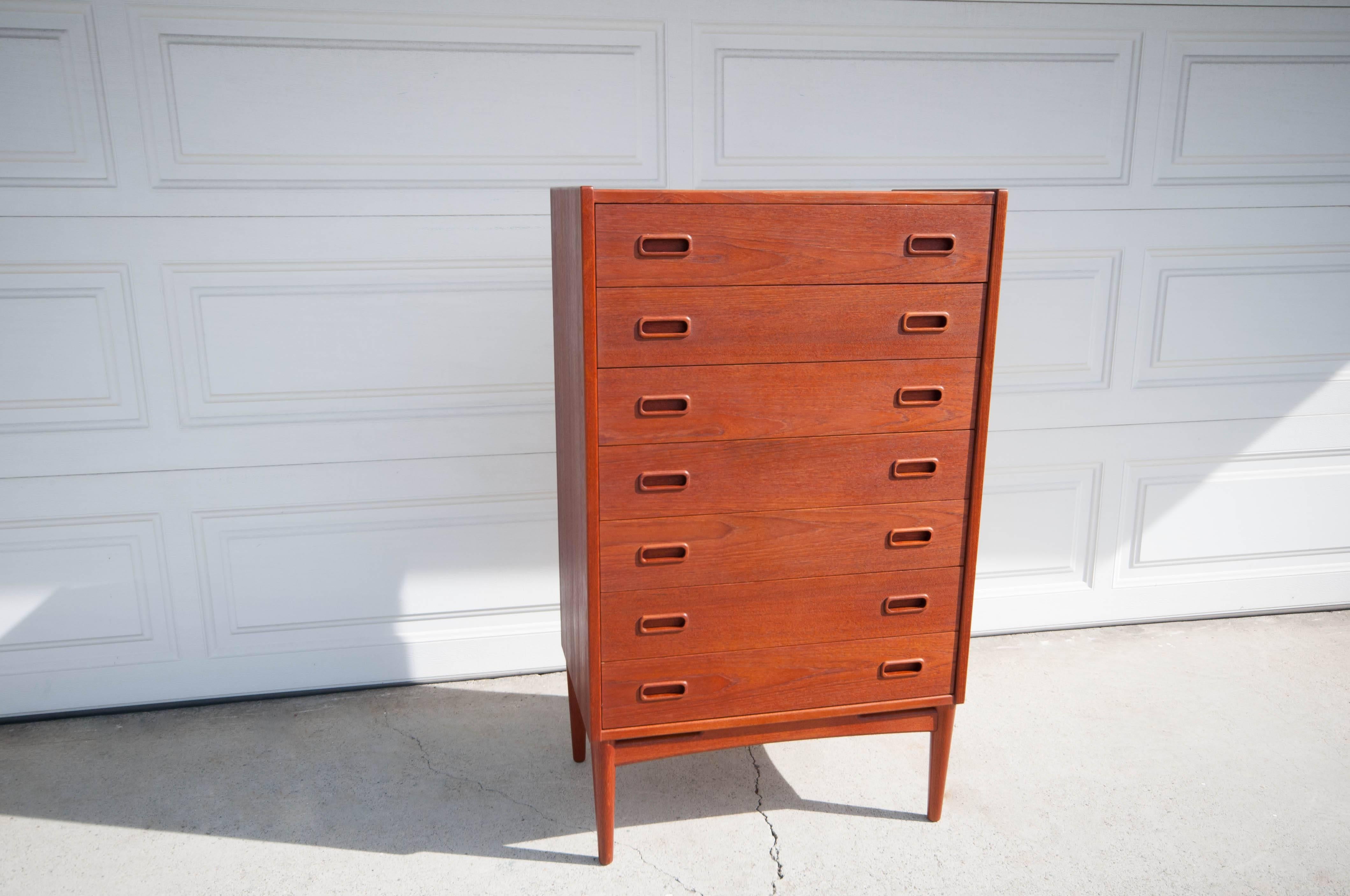 Danish Dresser by Mogens Kold in teak. This piece features seven dovetailed drawers with unique sculpted wood handles. It is in great condition with minimal vintage wear. 

