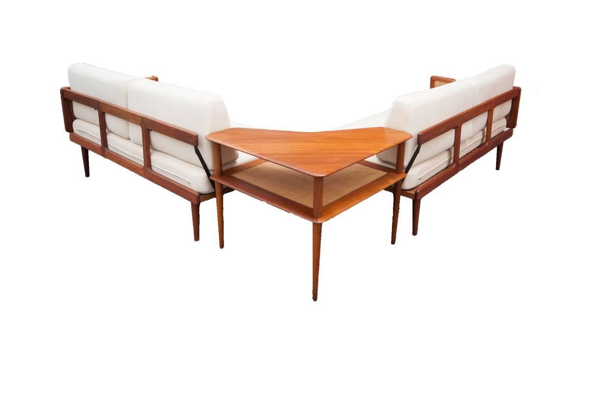 Danish 3 pc. Sofa Sectional set designed by Peter Hvidt and Orla Molgaard-Nielsen for France and Son. This piece features beautifully sculpted teak armrests with caning. Includes corner table that displays a woven cane top and solid teak
