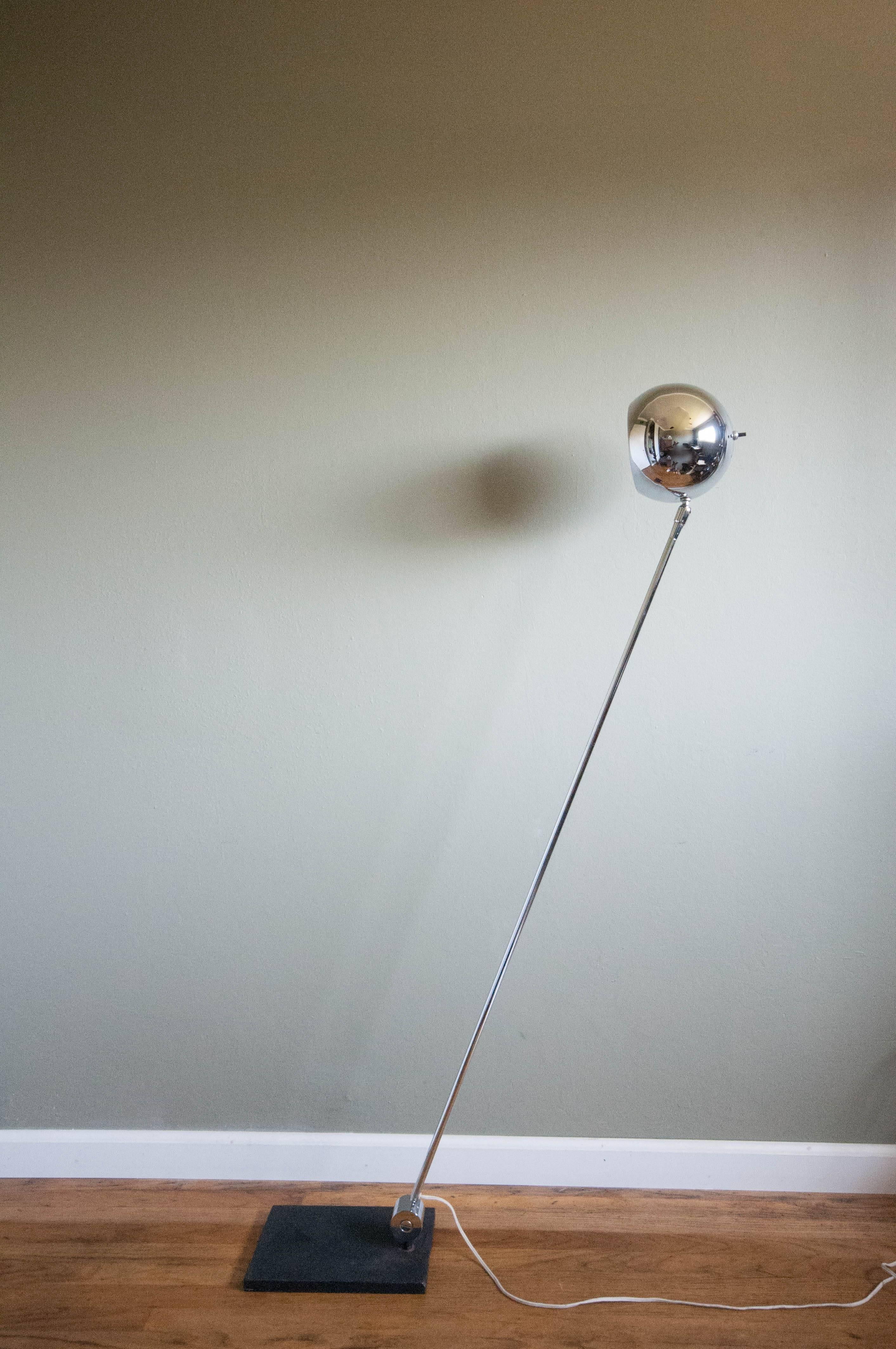 Mid Century Adjustable Floor Lamp designed by Robert Sonneman in polished chrome. This piece can be adjusted from the base and head tilts up and down.

