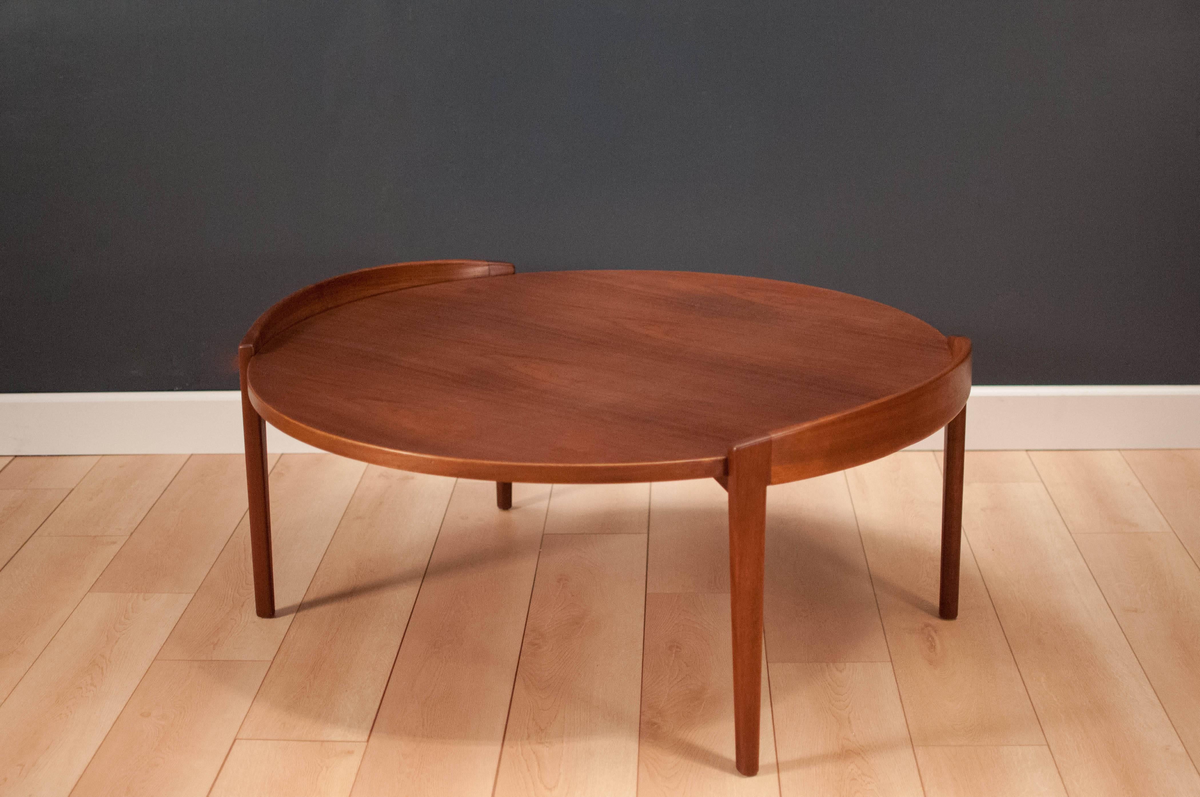 Mid-Century Modern coffee table by Jens Risom in walnut. This timeless piece features a solid sculpted raised edge and a gorgeous wood grain top. 

        