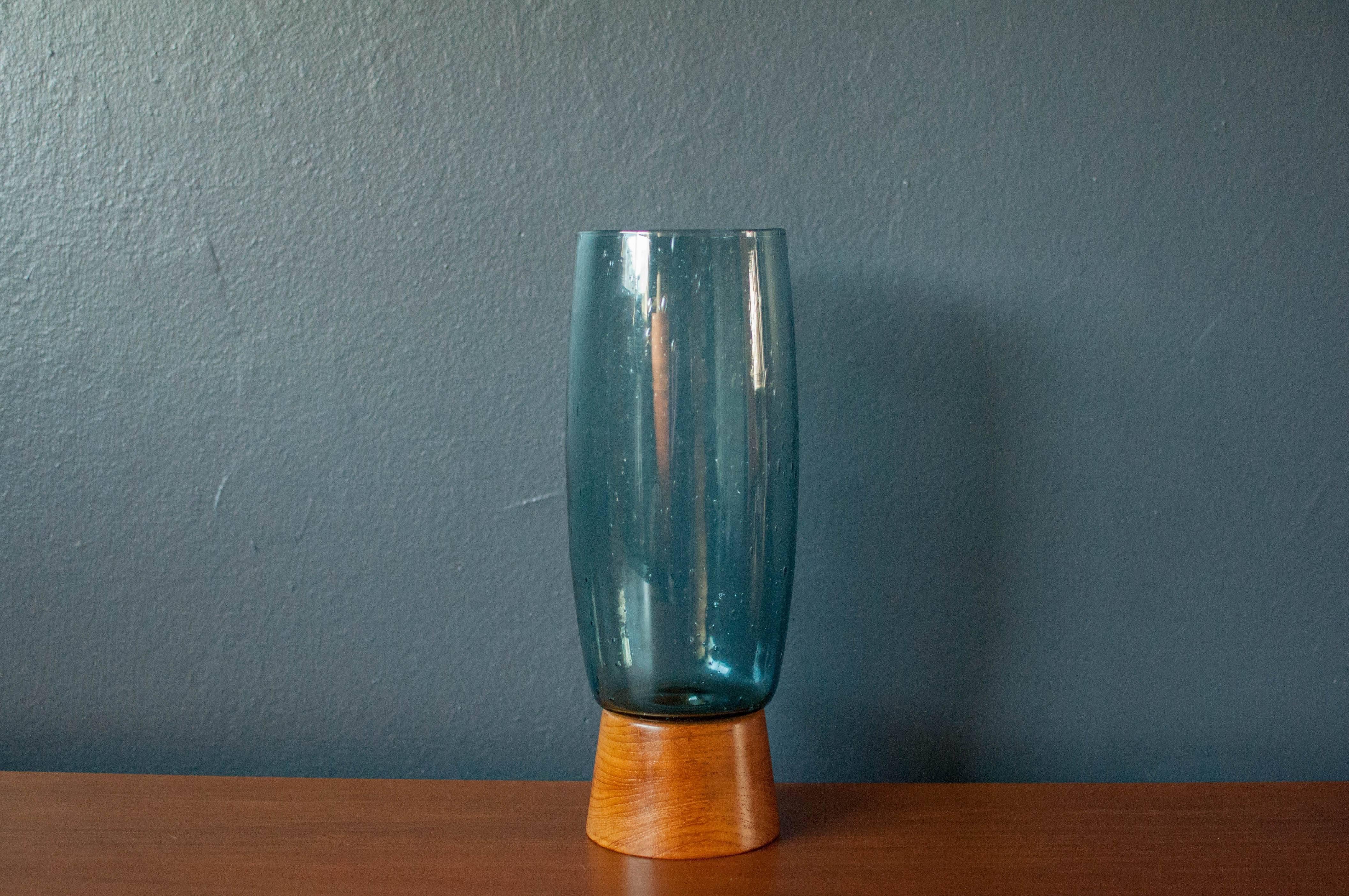 Vintage Bubbled Glass and Walnut Vase by Raymor. This rare piece comes in a tinted blue shade and is in good condition with minimal vintage wear. 
