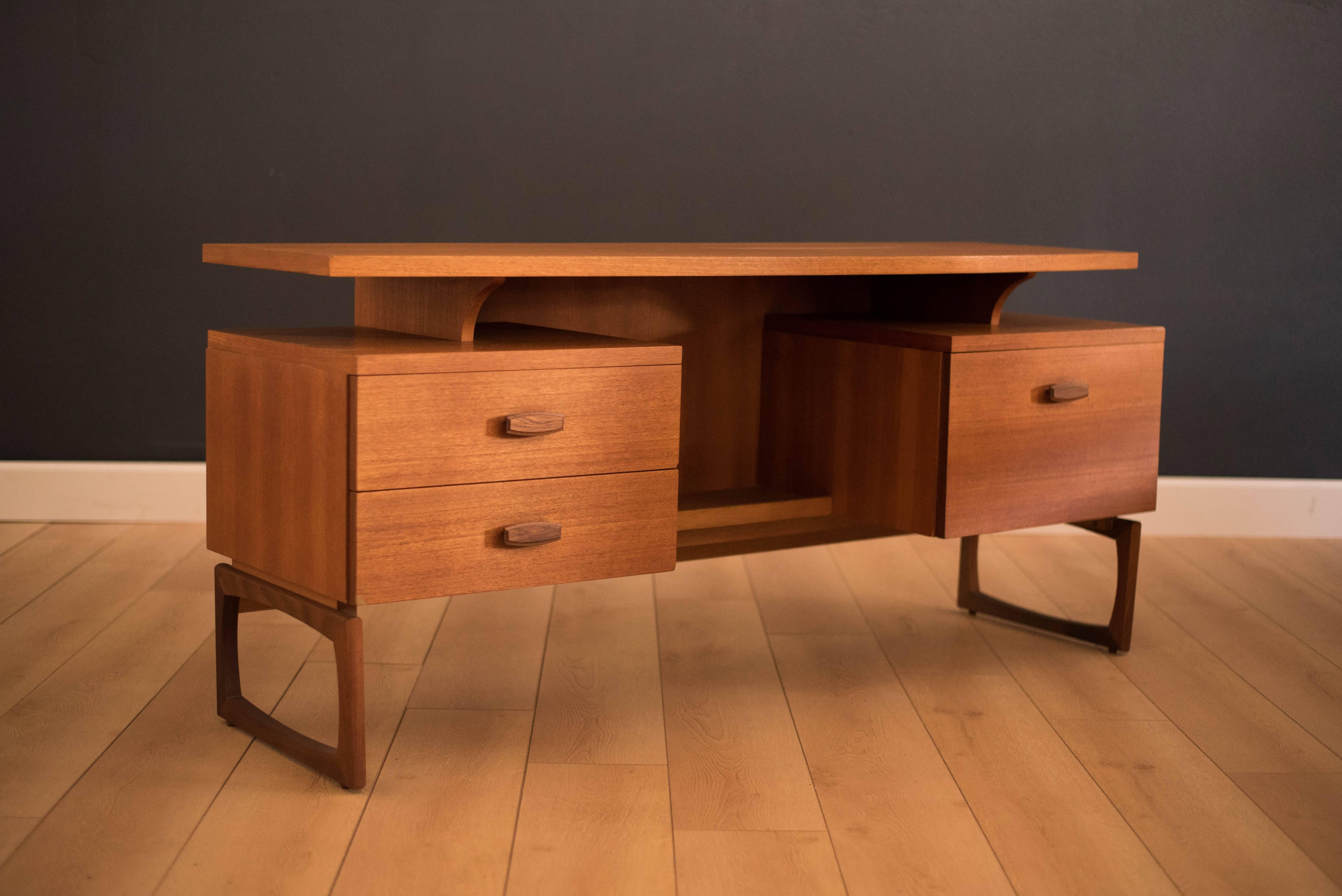 Mid-Century Modern G Plan vanity from the 'Quadrille' series. This piece comes with two drawers and one open storage cabinet with an accessory compartment. The top features a unique bowed shape and has a floating appearance which allows storage