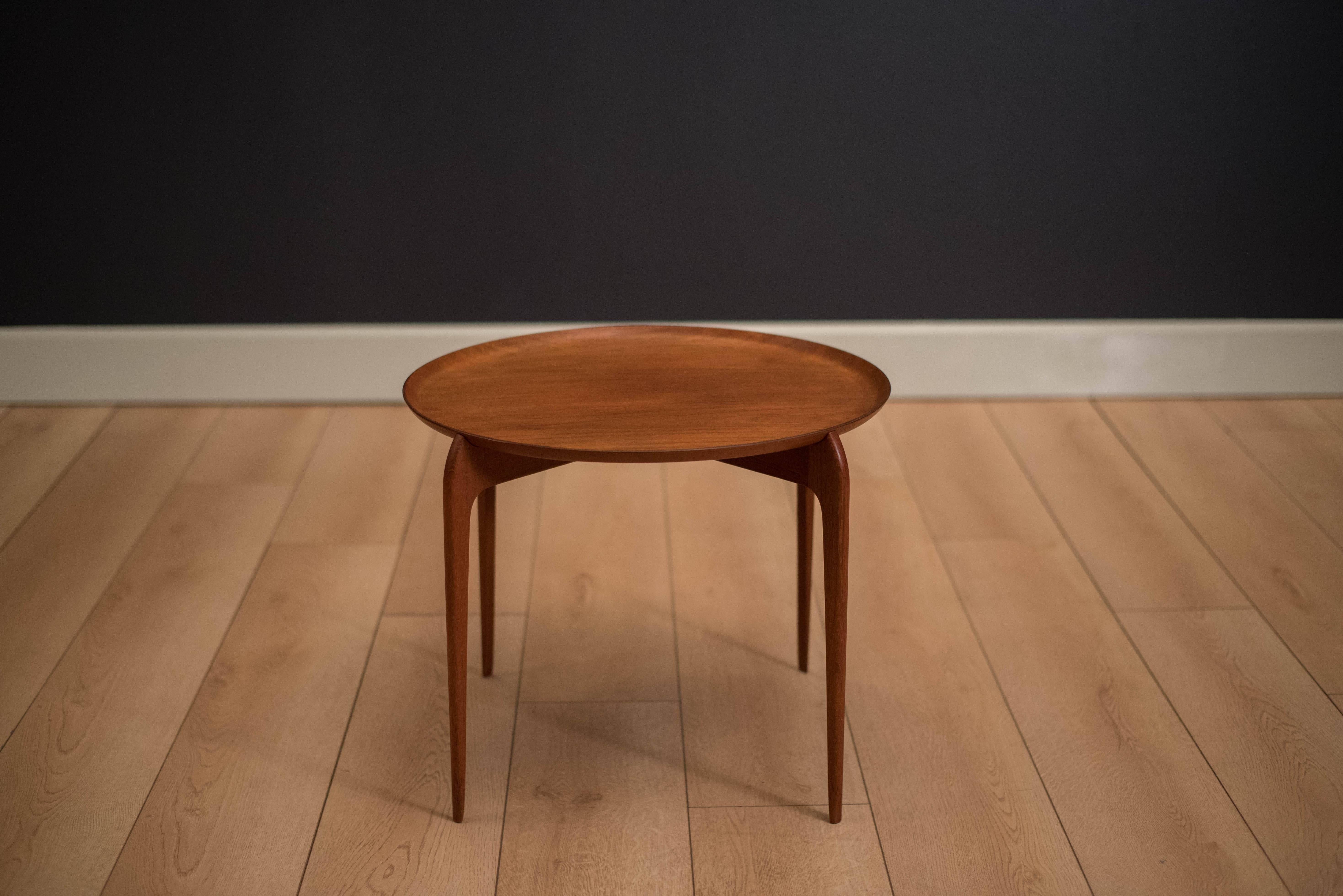 Vintage round side table in teak imported by Moreddi, circa 1960s. This piece has unique sculpted legs that secures the removable tray top in place. 

 