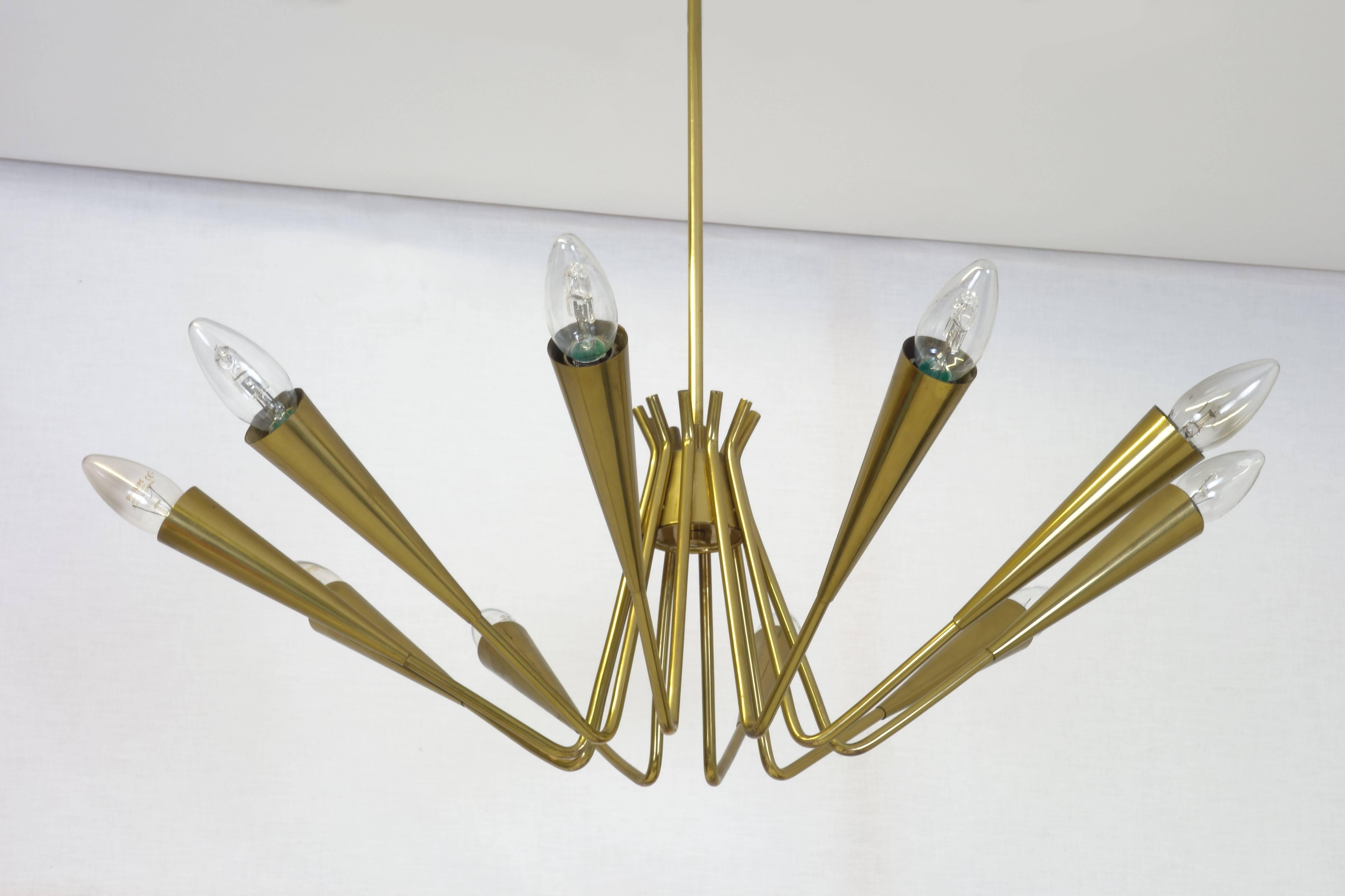 Beautifully patinated Sputnik Age chandelier in solid brass. This object is equipped with ten bulbs and can be switched on in two stages. On demand we can deliver this chandelier patinated or high gloss polished.