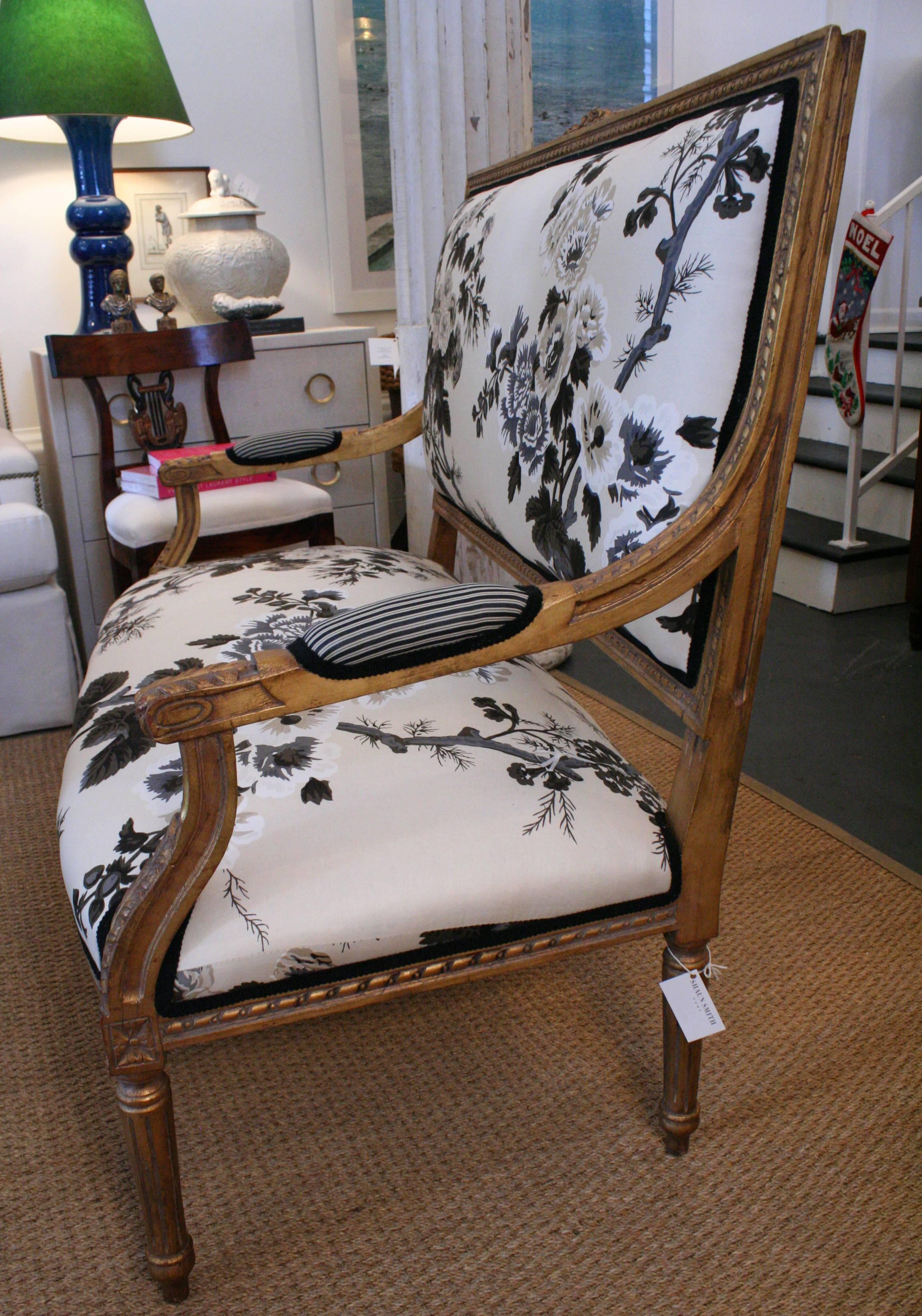 18th century Louis XVI style giltwood settee. Reupholstered in floral cotton fabric by Schumacher. Back is upholstered in striped cotton fabric by Scalamandre.