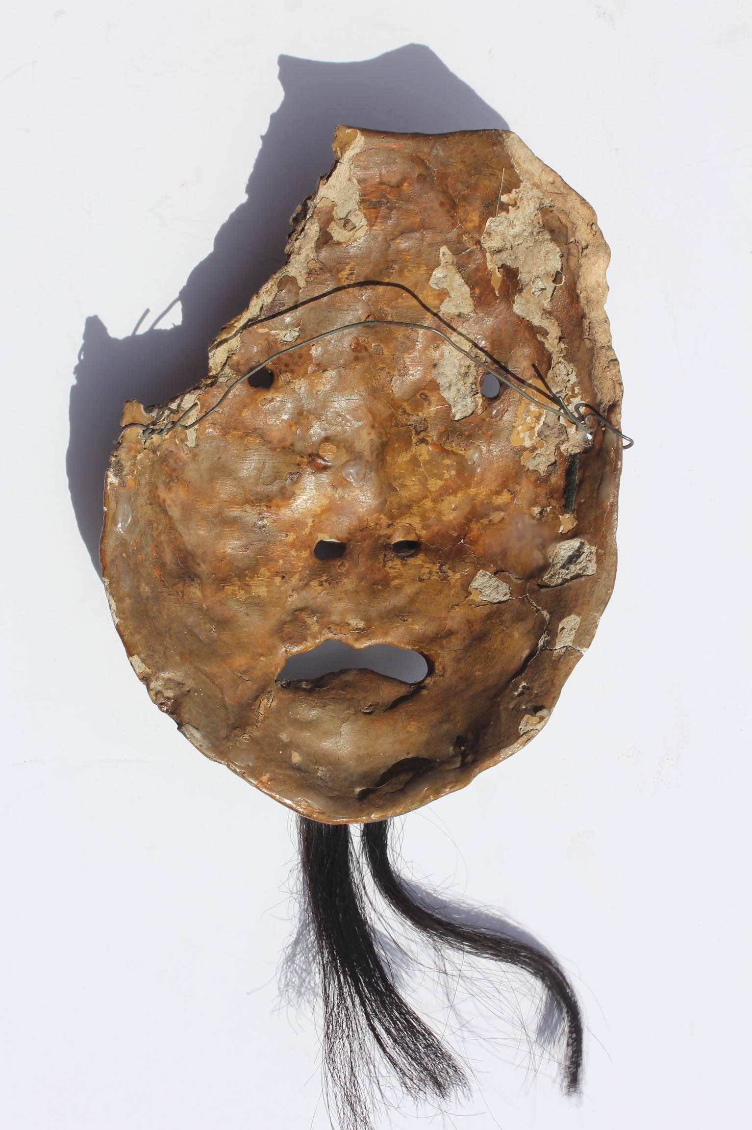 Asian mask fragment. Circa 1900.