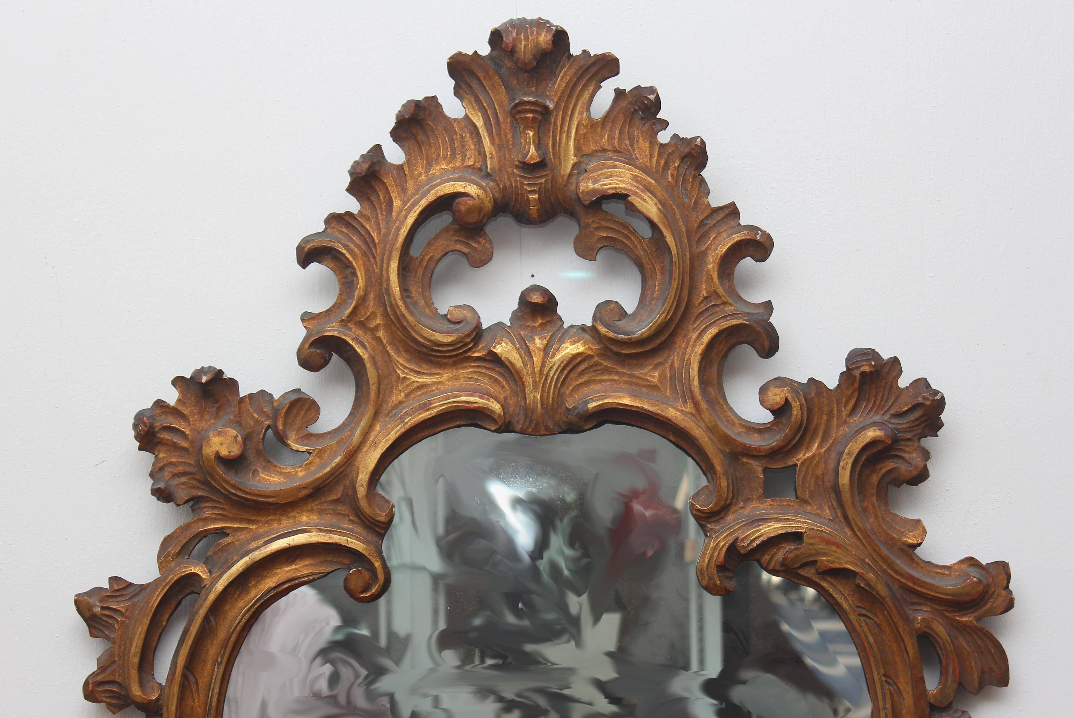 Large Venetian Rococo style carved giltwood mirror. Excellent quality.