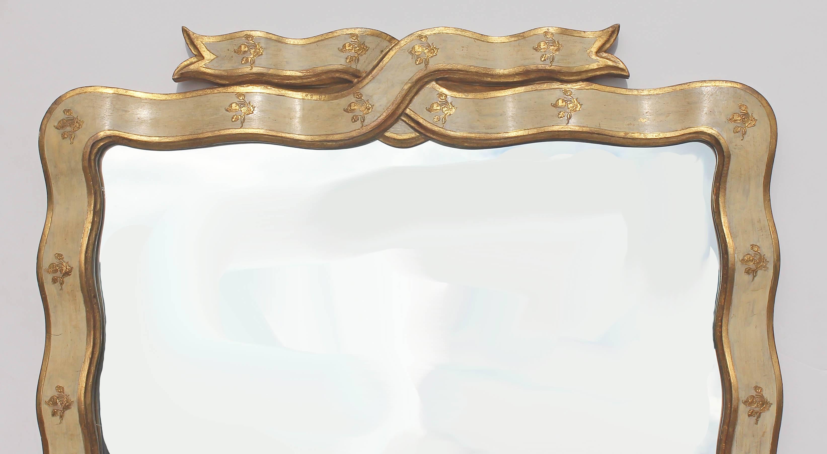 Italian Florentine painted and parcel-gilt ribbon form mirror. Carved wood, circa 1950s.