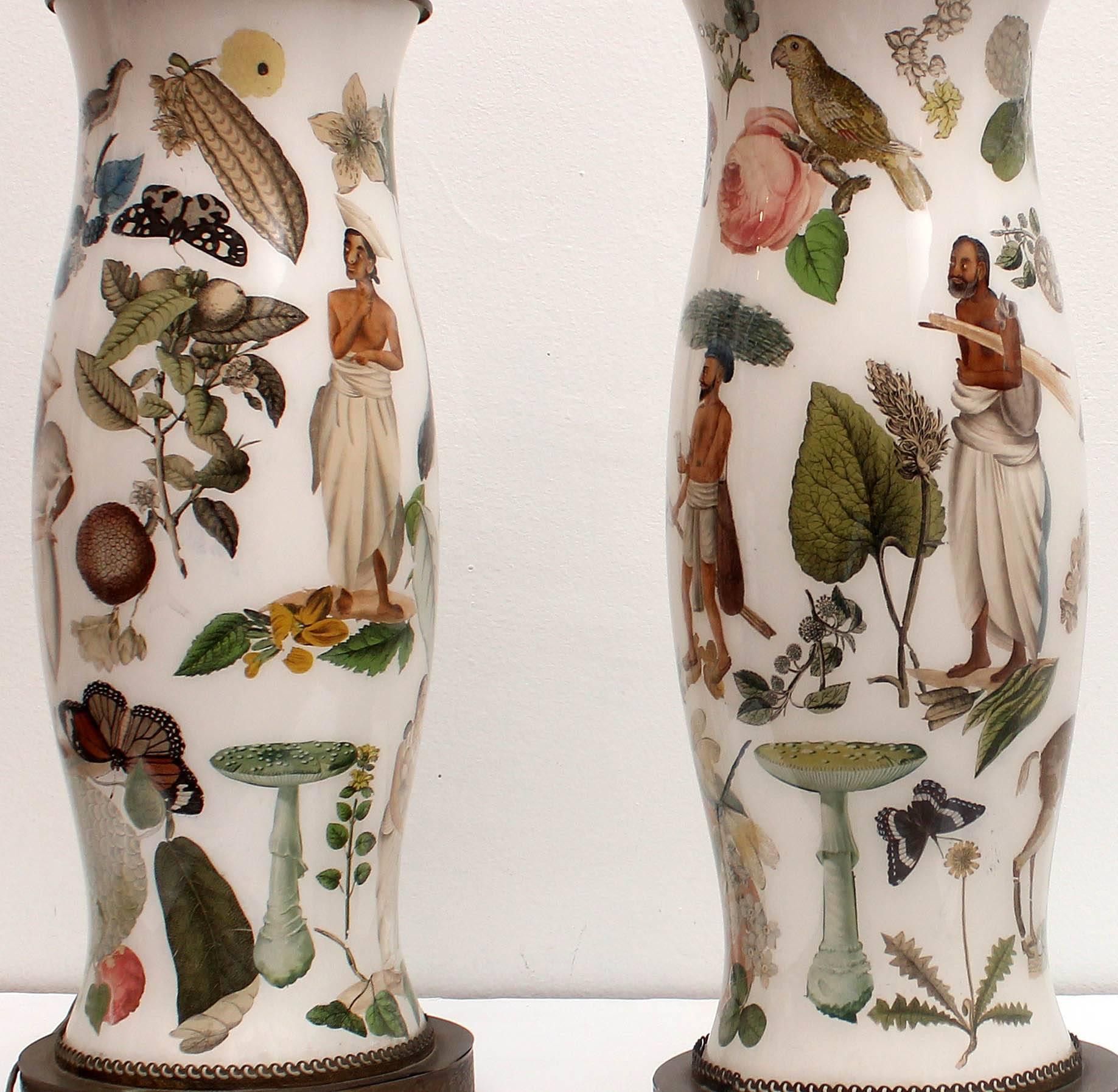 Pair of antique reverse decorated decalcomanie glass lamps. Bright and colorful, they are decorated with exotic flora, fauna, and eastern figures in ethnic dress. Decalcomanie, is a decorative technique by which engravings and prints may be