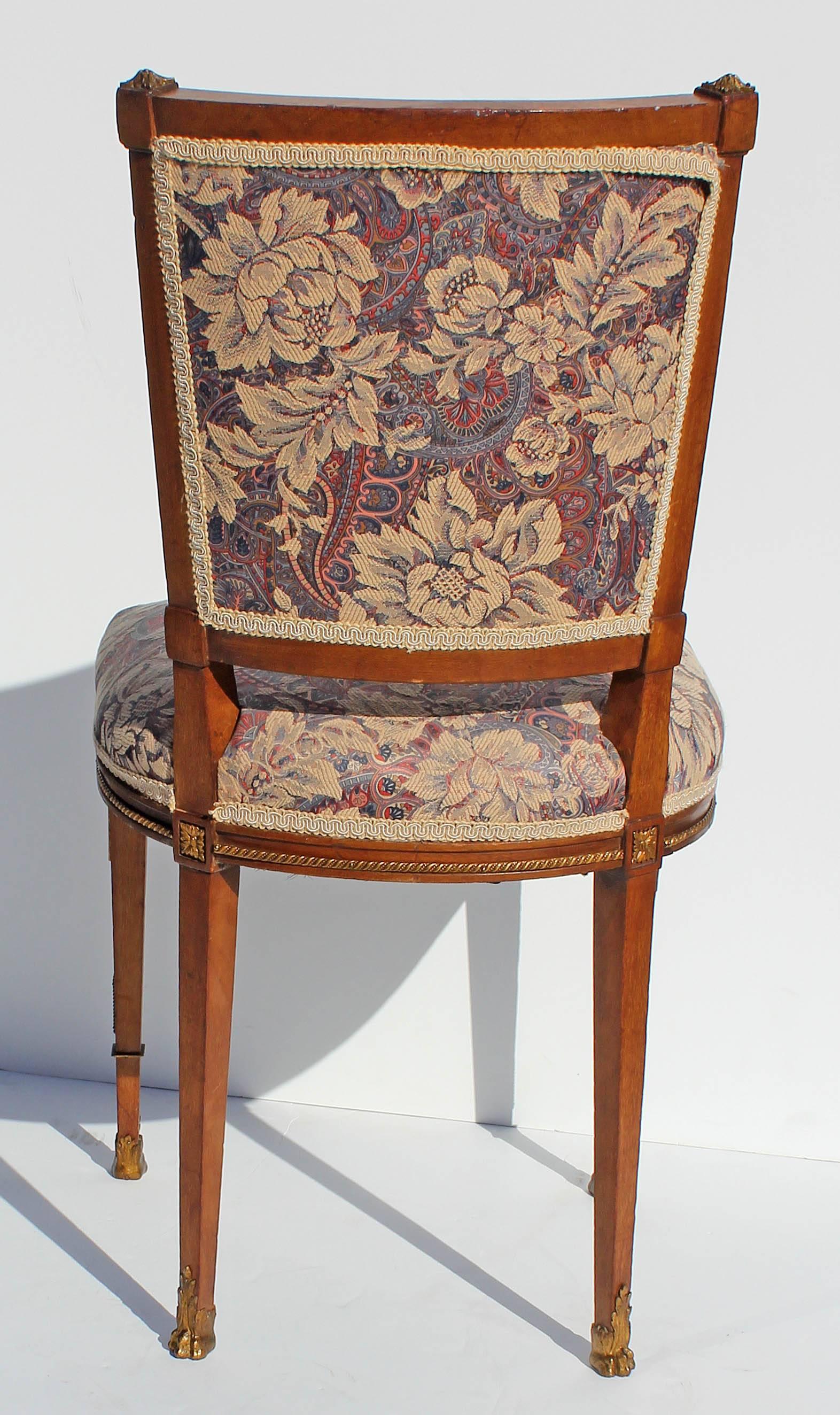 Antique petite French Louis XVI boudoir style side chair. Fruitwood with gilt mounts, late 19th century.
