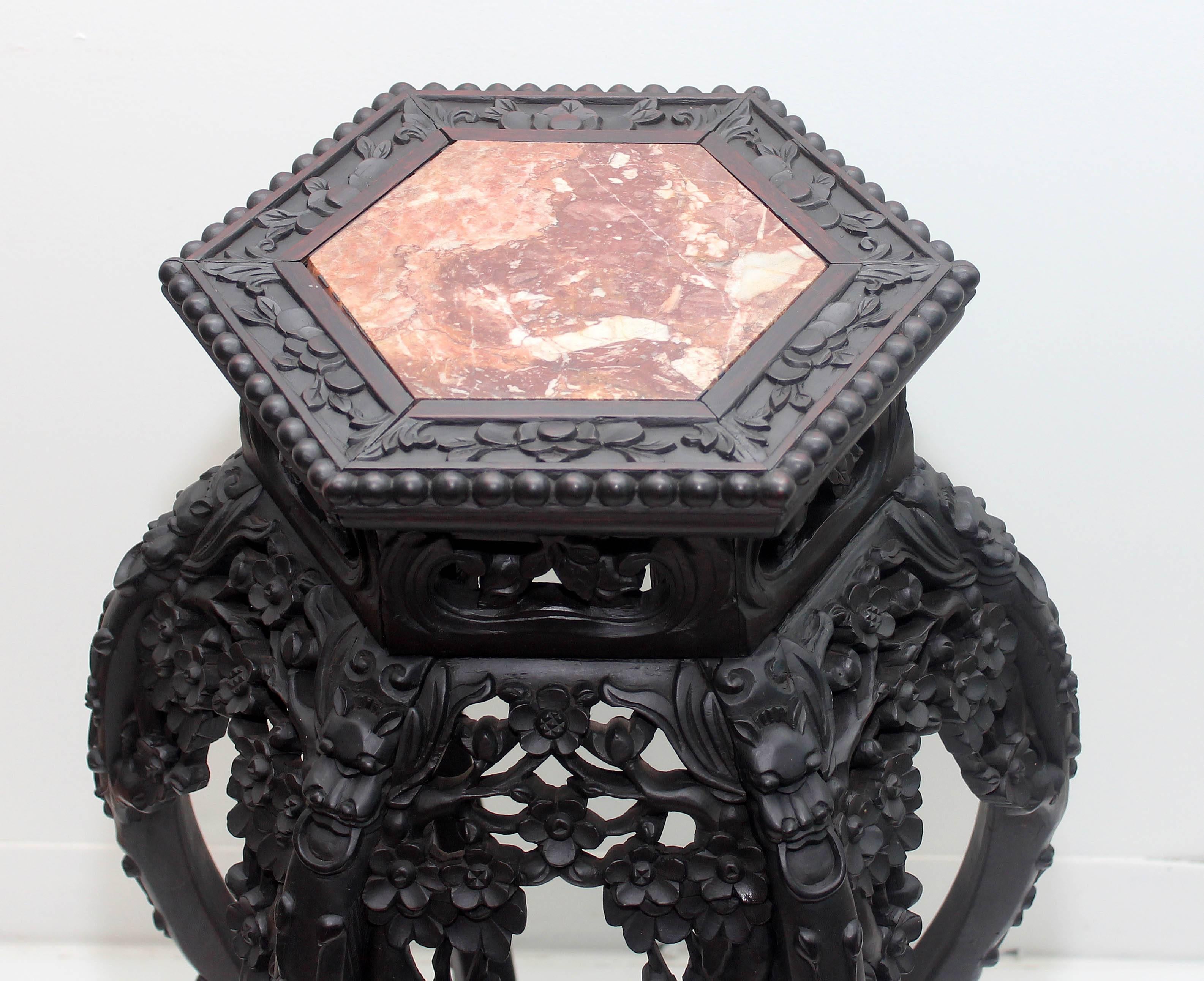 Antique Chinese carved hardwood pedestal table. Pierced carved, with octagonal marble-top, late 19th century.