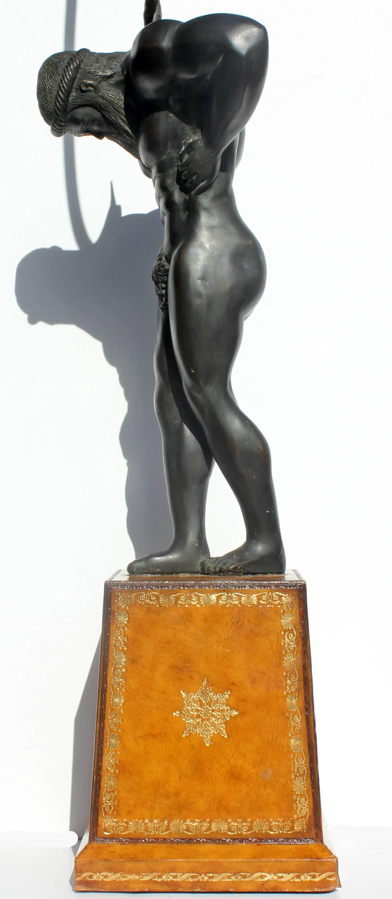 Globe stand bronze figure of atlas mounted on Italian tooled leather base, circa 1960s. Measures: 53" high.