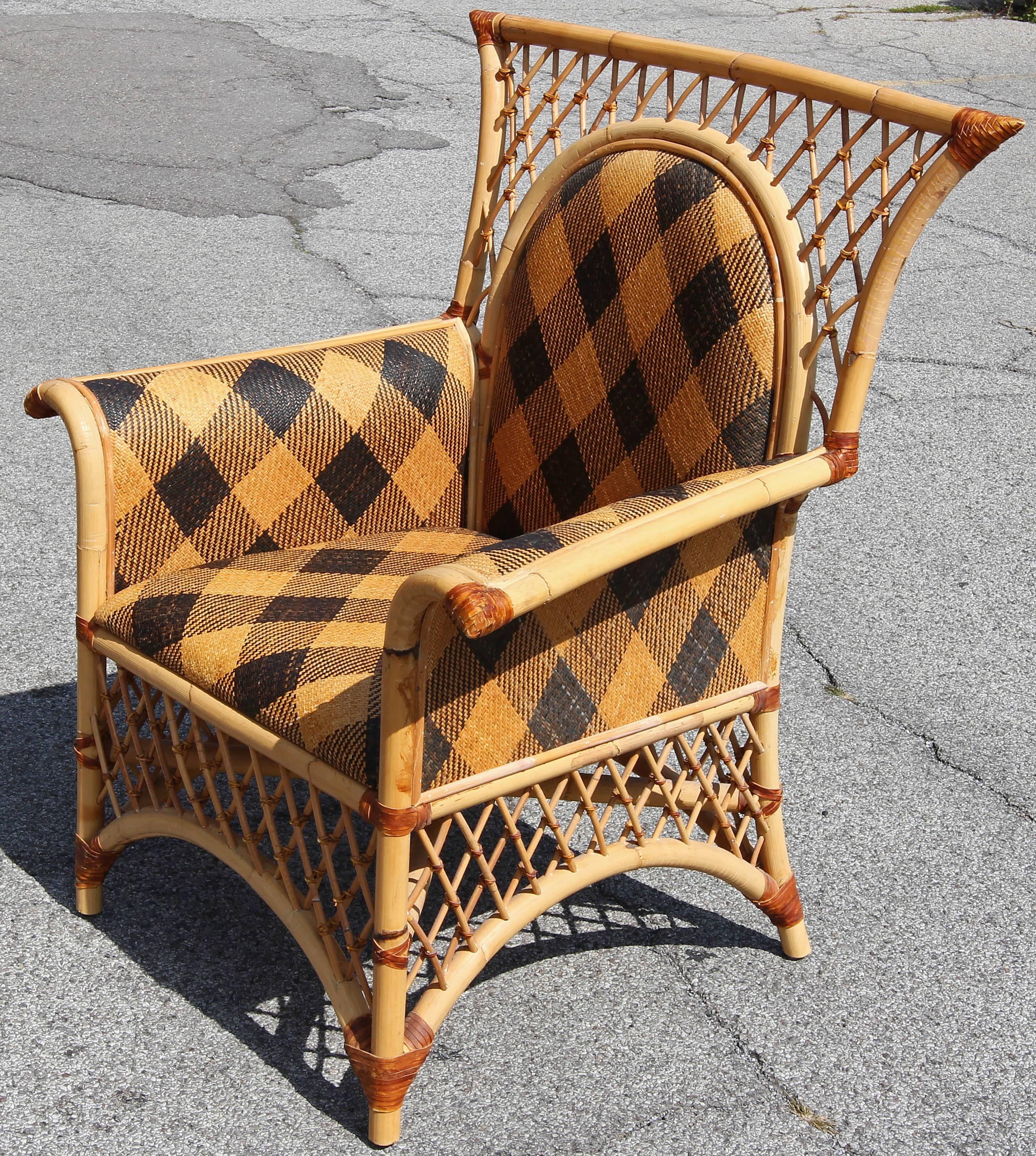 Mackenzie Child’s rattan lounge chair. Leather strapped bamboo frame. Woven cane upholstery in the harlequin pattern. Very comfortable.