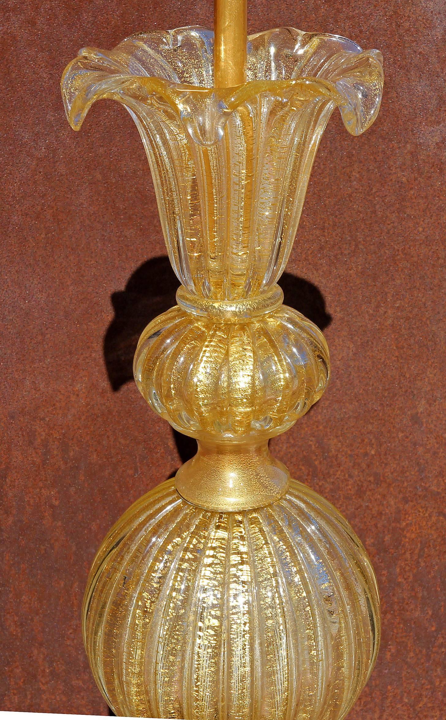 Pair of vintage Murano glass lamps. An elegant design. Clear glass with 24-karat gold interior decoration. Height to top of socket 30". Height to top of urn 25".