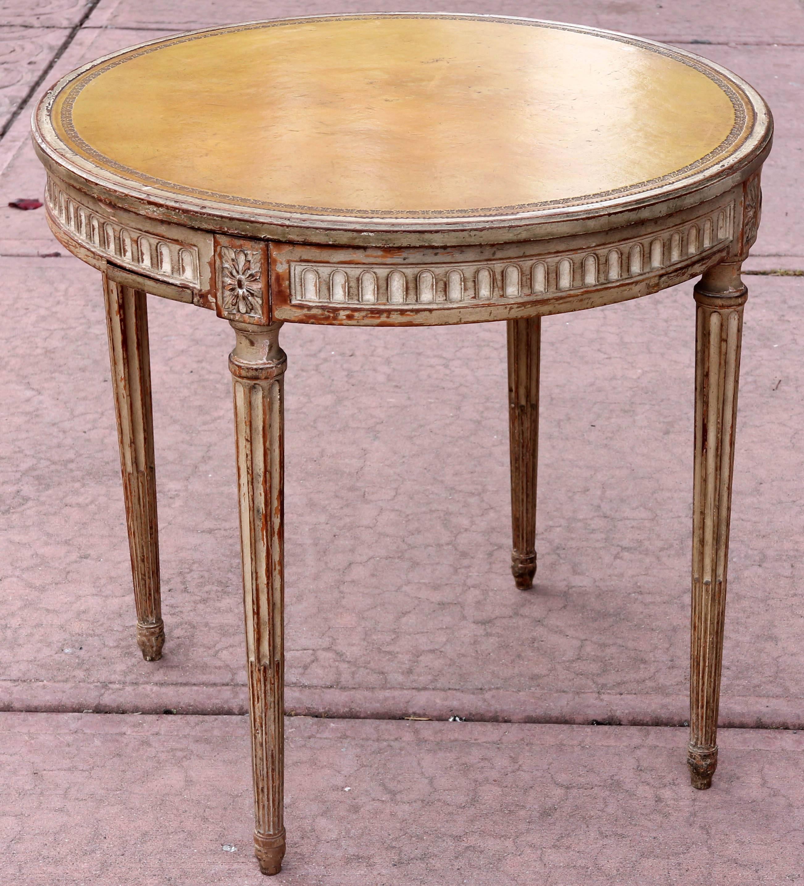 Antique Italian painted and carved neoclassical style table with tooled leather top. Top is removable to reveal leather backgammon board on base. Top has an inlaid chess board on the under side. Four concealed cup holders for game chips, late 19th